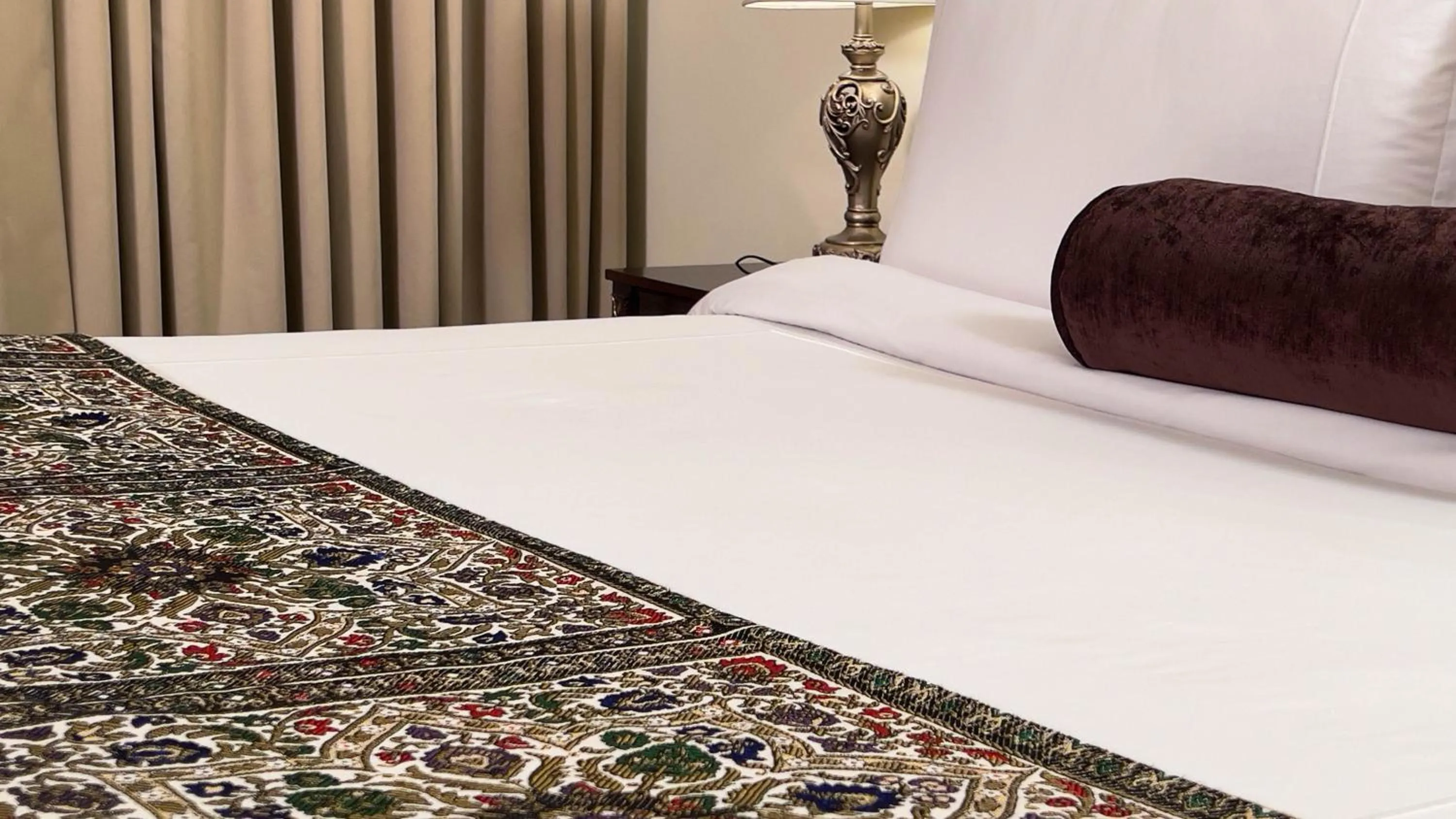 Bed in Heritage Luxury Suites All Suite Hotel