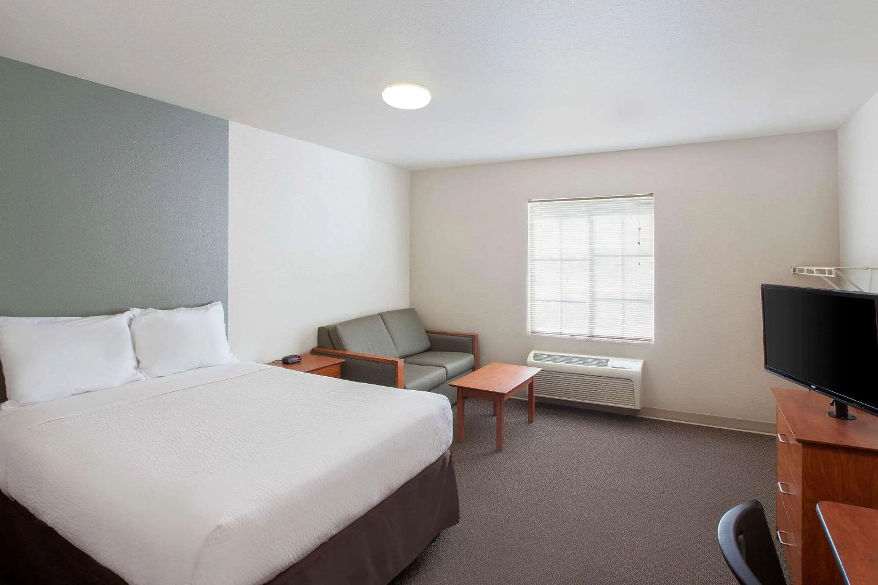 Photo of the whole room, Bed in WoodSpring Suites Jacksonville Beach Blvd