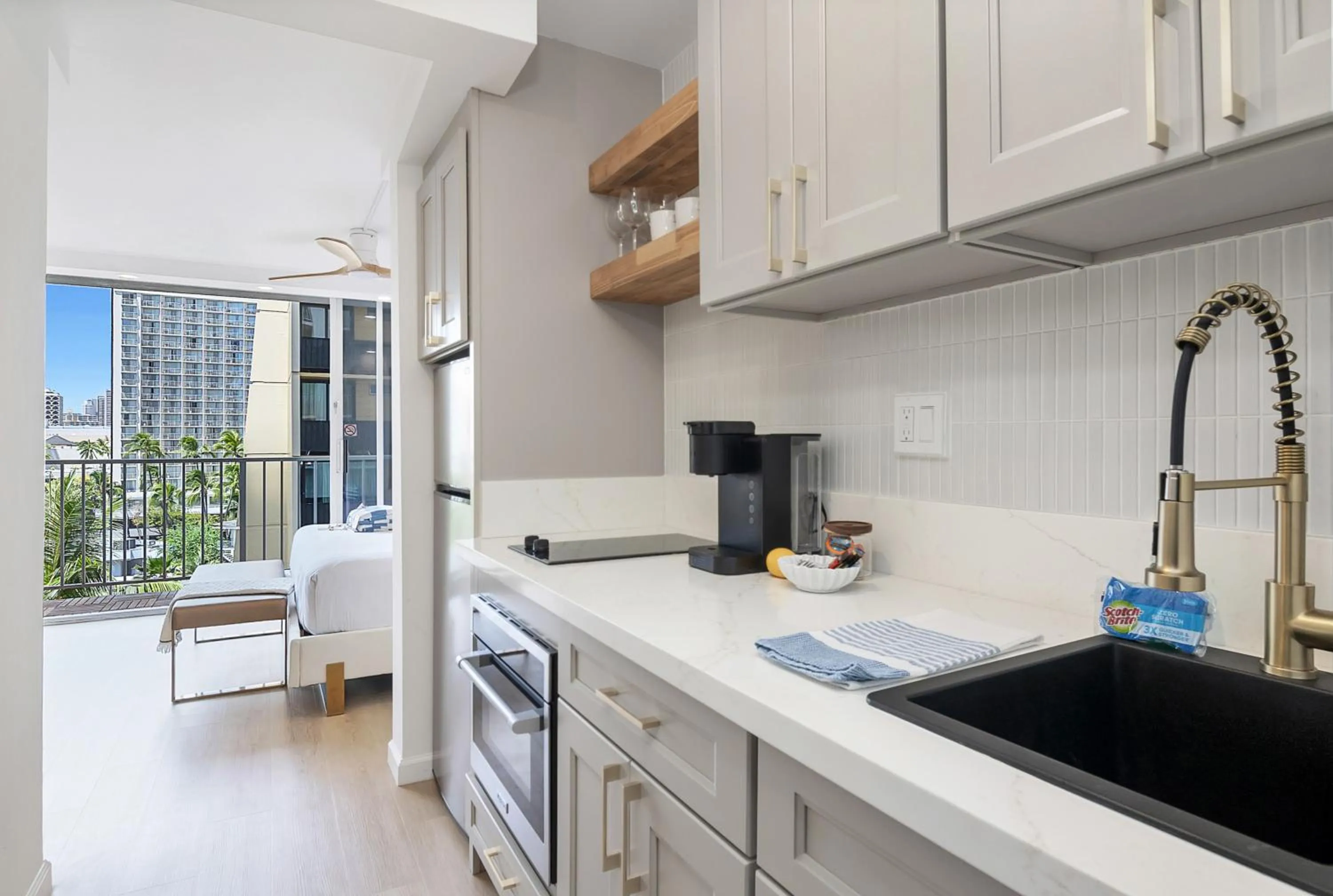 Kitchen or kitchenette in Steps to Waikiki Beach! Newly Renovated with 75" TV