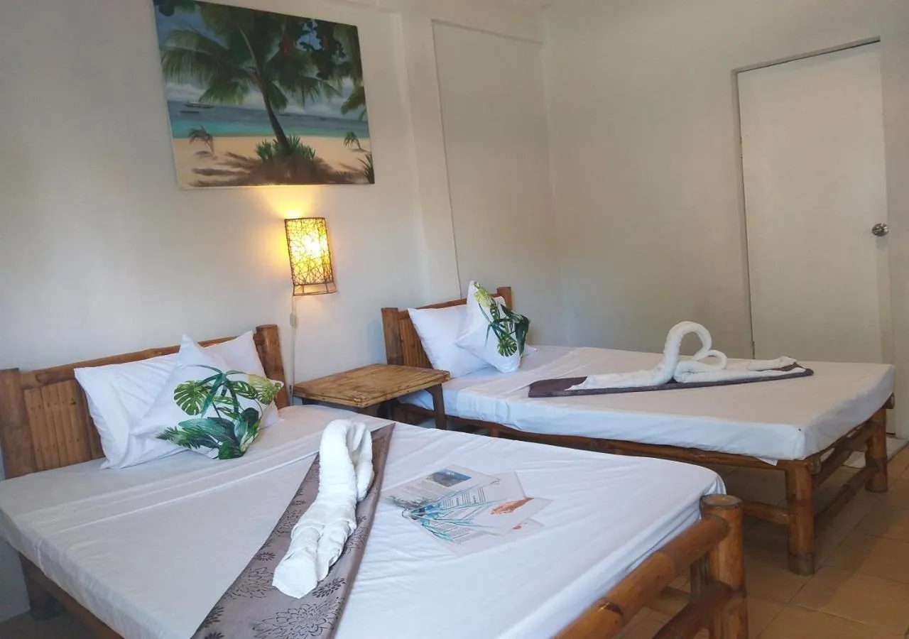 Bed in The Shark's Tail Dive Resort