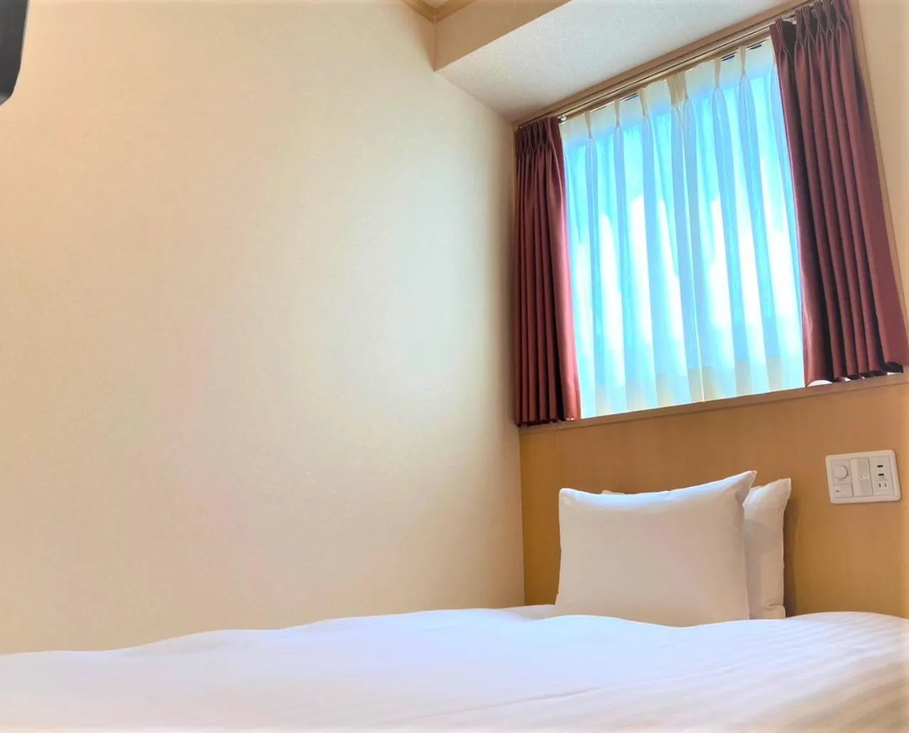 Bed in SAKURA SKY HOTEL KASHIWA(桜スカイホテル柏)