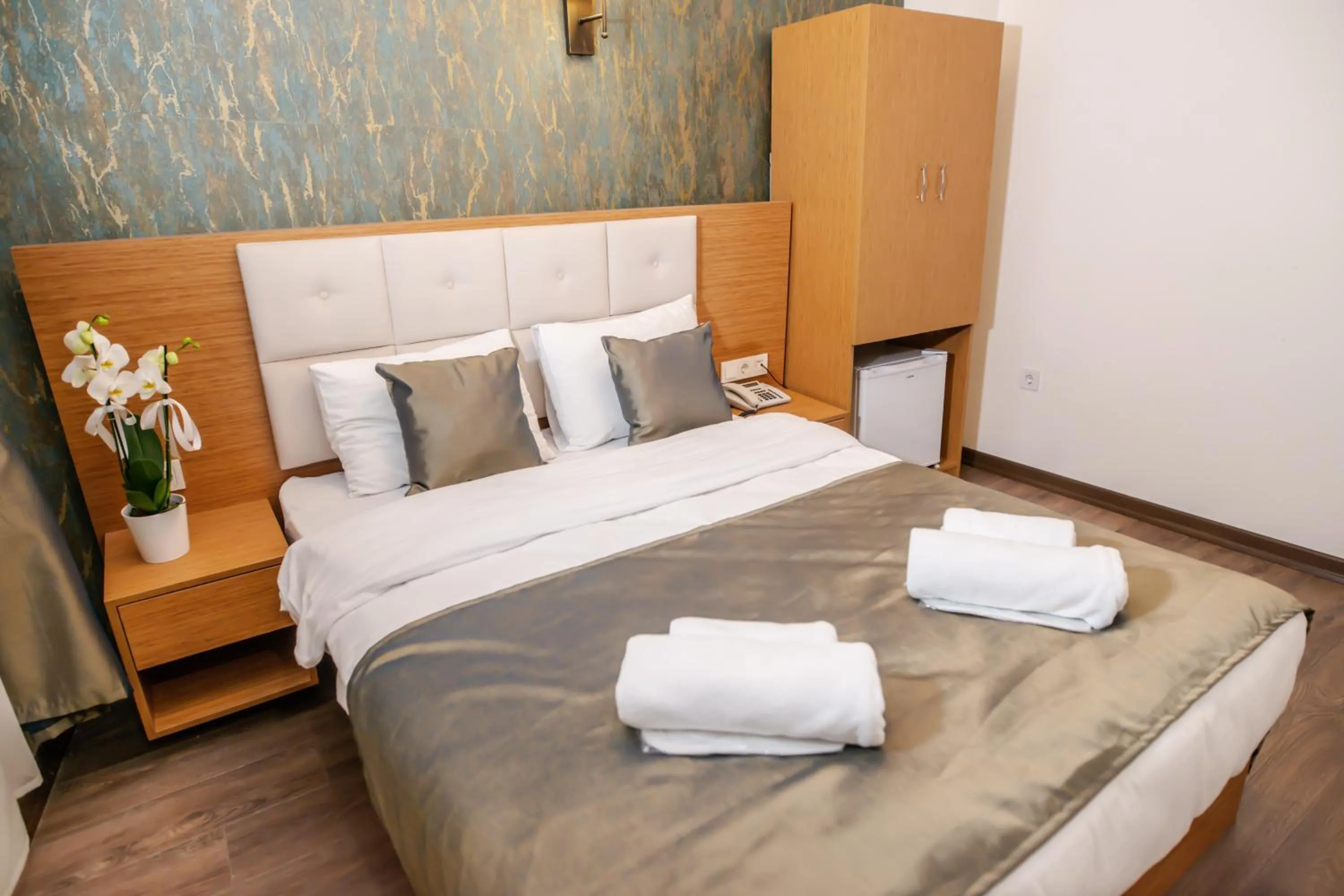 Bed in The Camelot Hotel