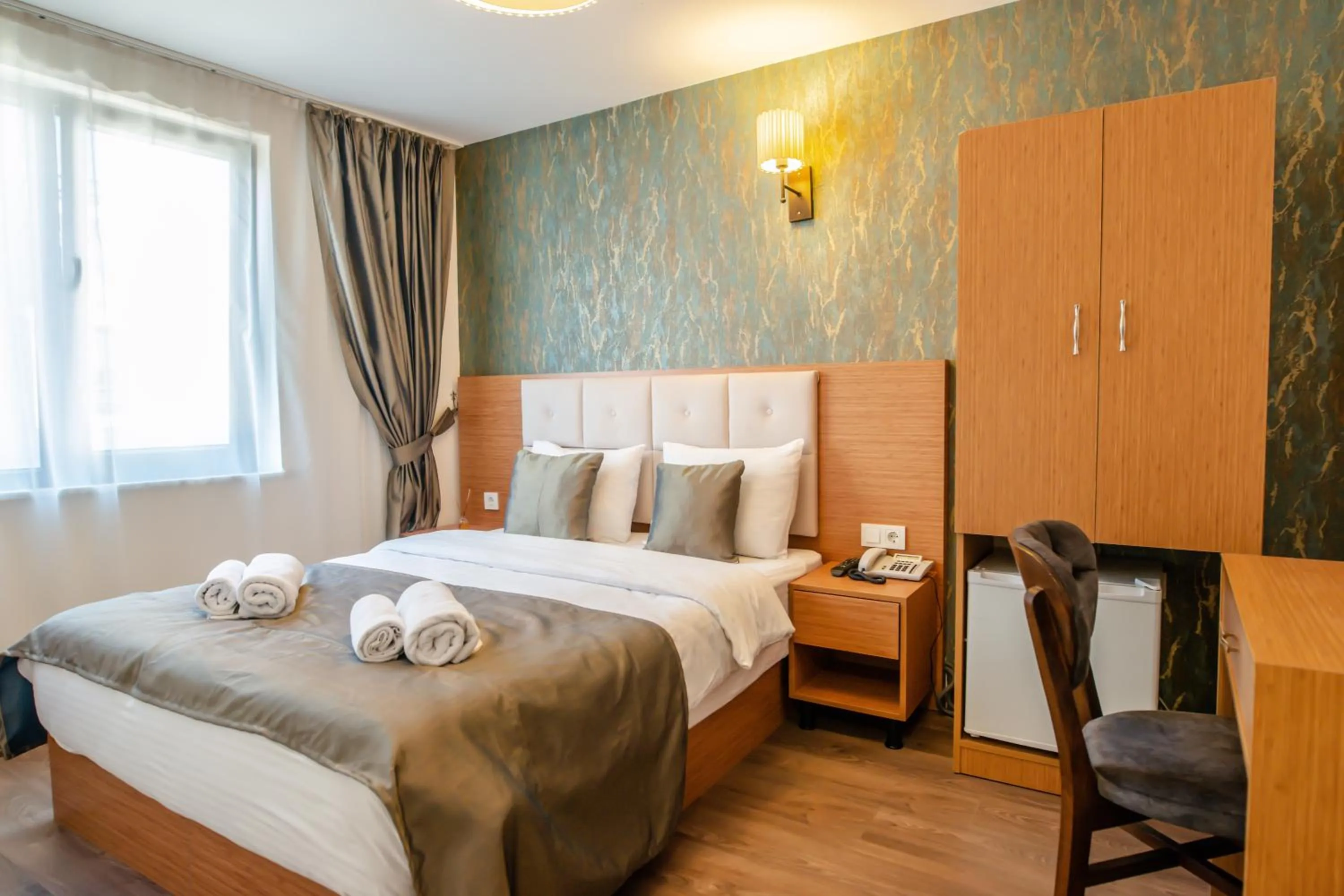 Bed in The Camelot Hotel