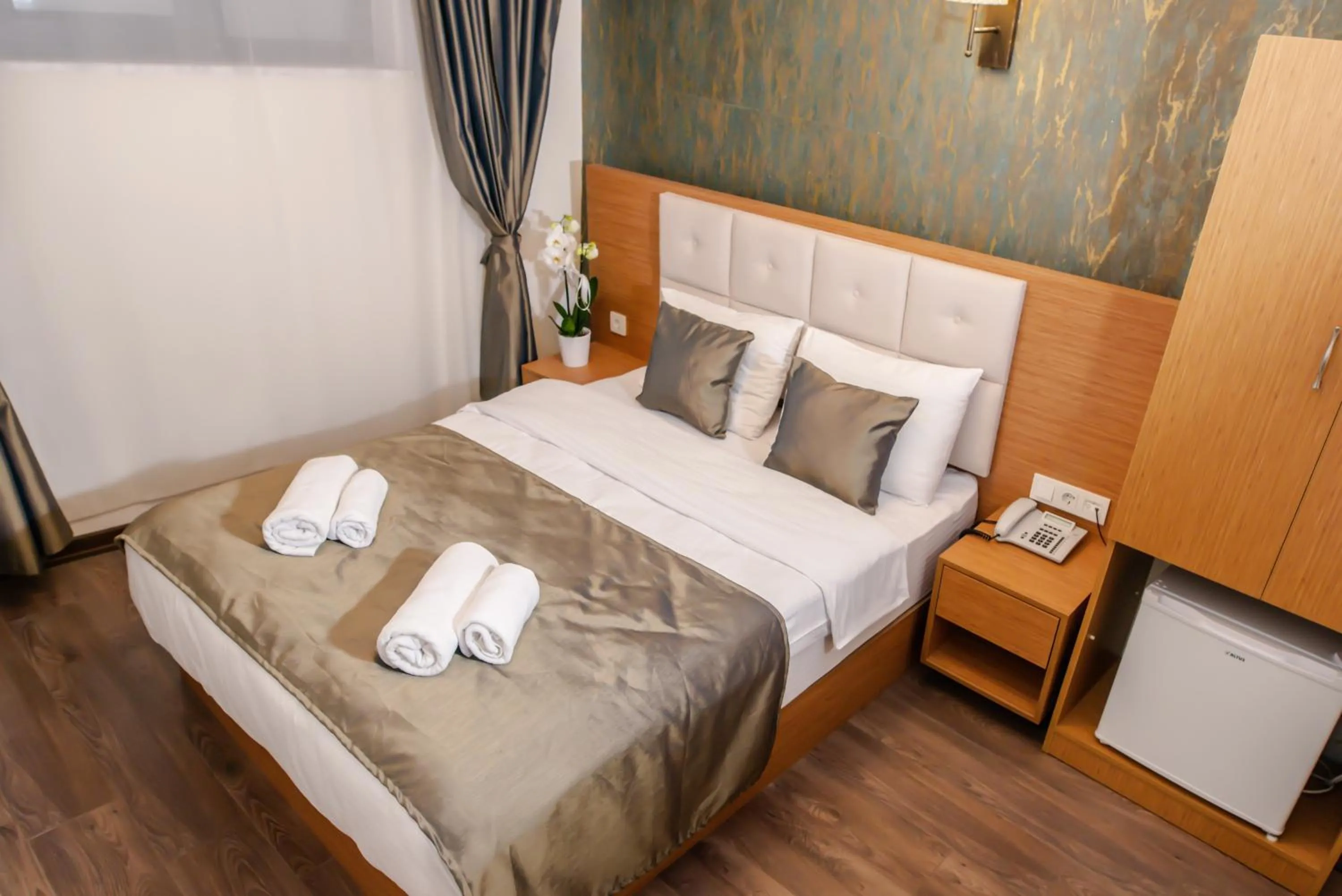 Bed in The Camelot Hotel