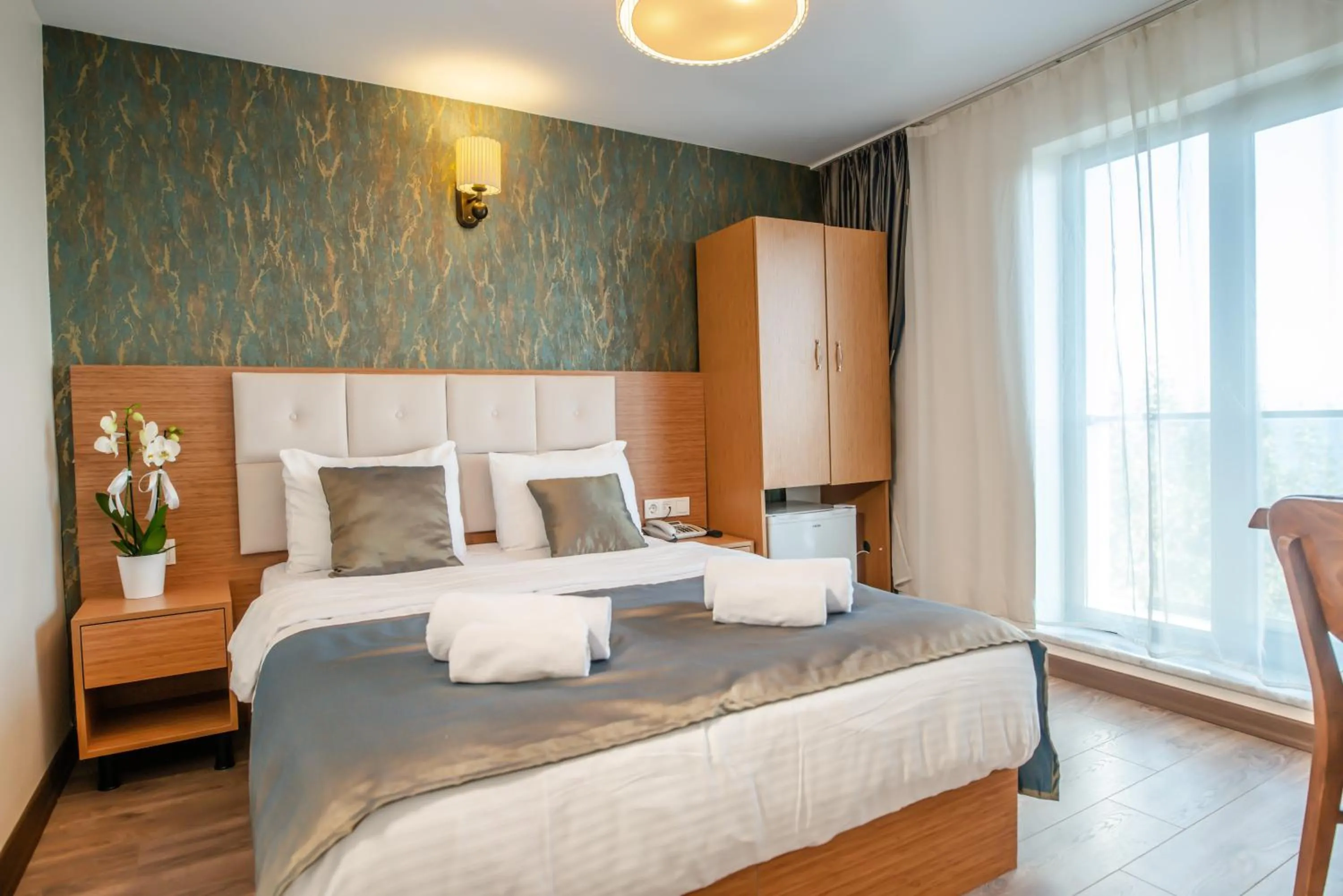 Bed in The Camelot Hotel