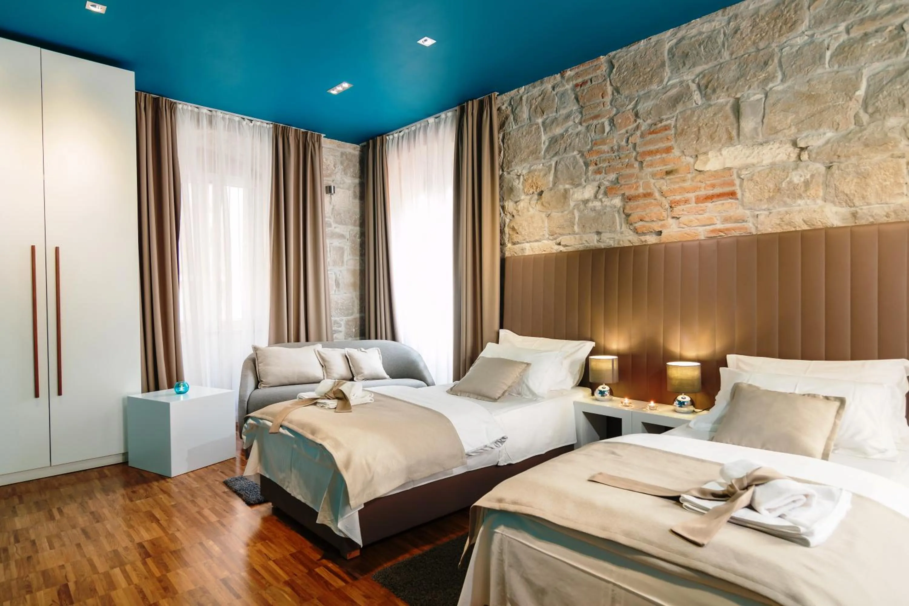 Bed in Riva Luxury Rooms