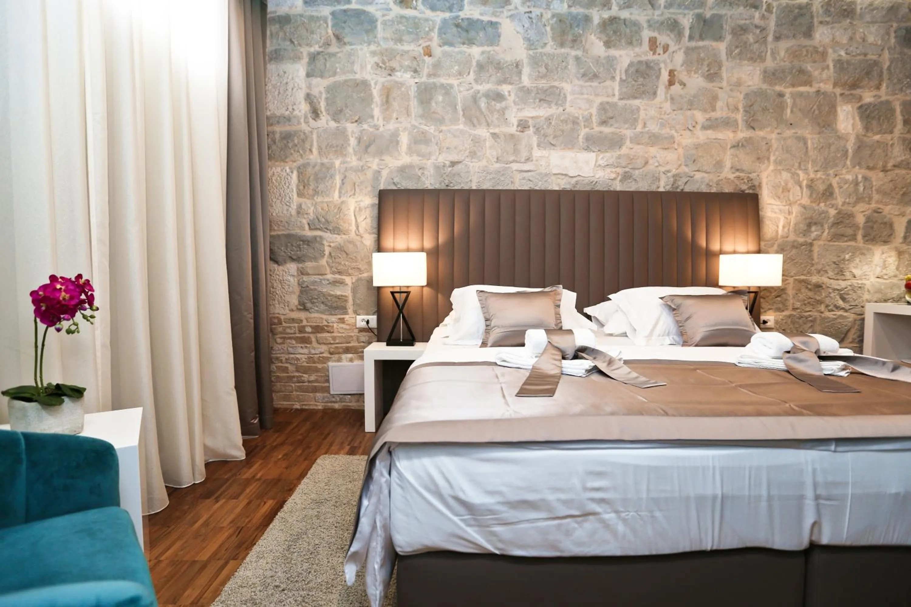 Bed in Riva Luxury Rooms