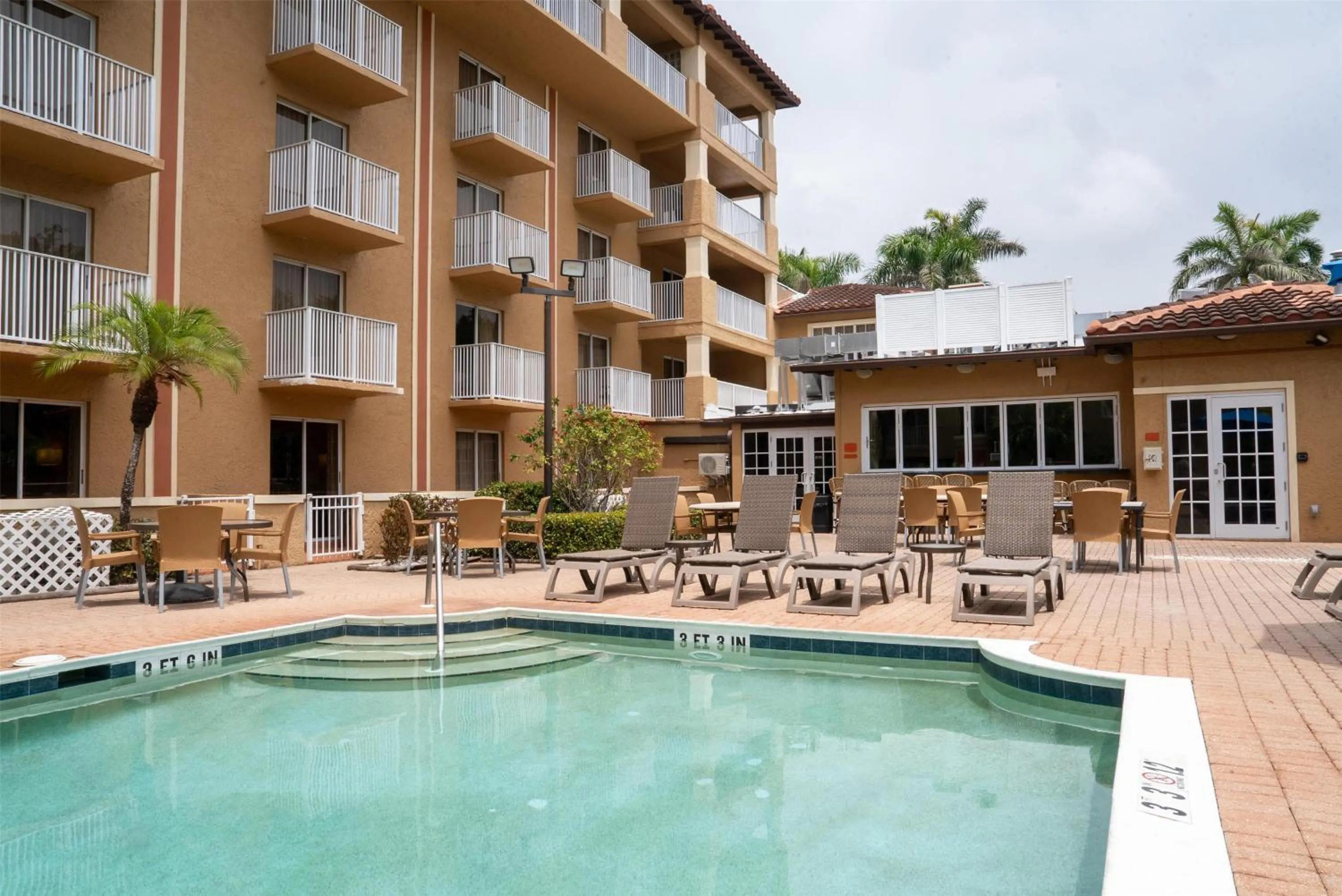 Pool view in Inn of Naples, Tapestry Collection by Hilton