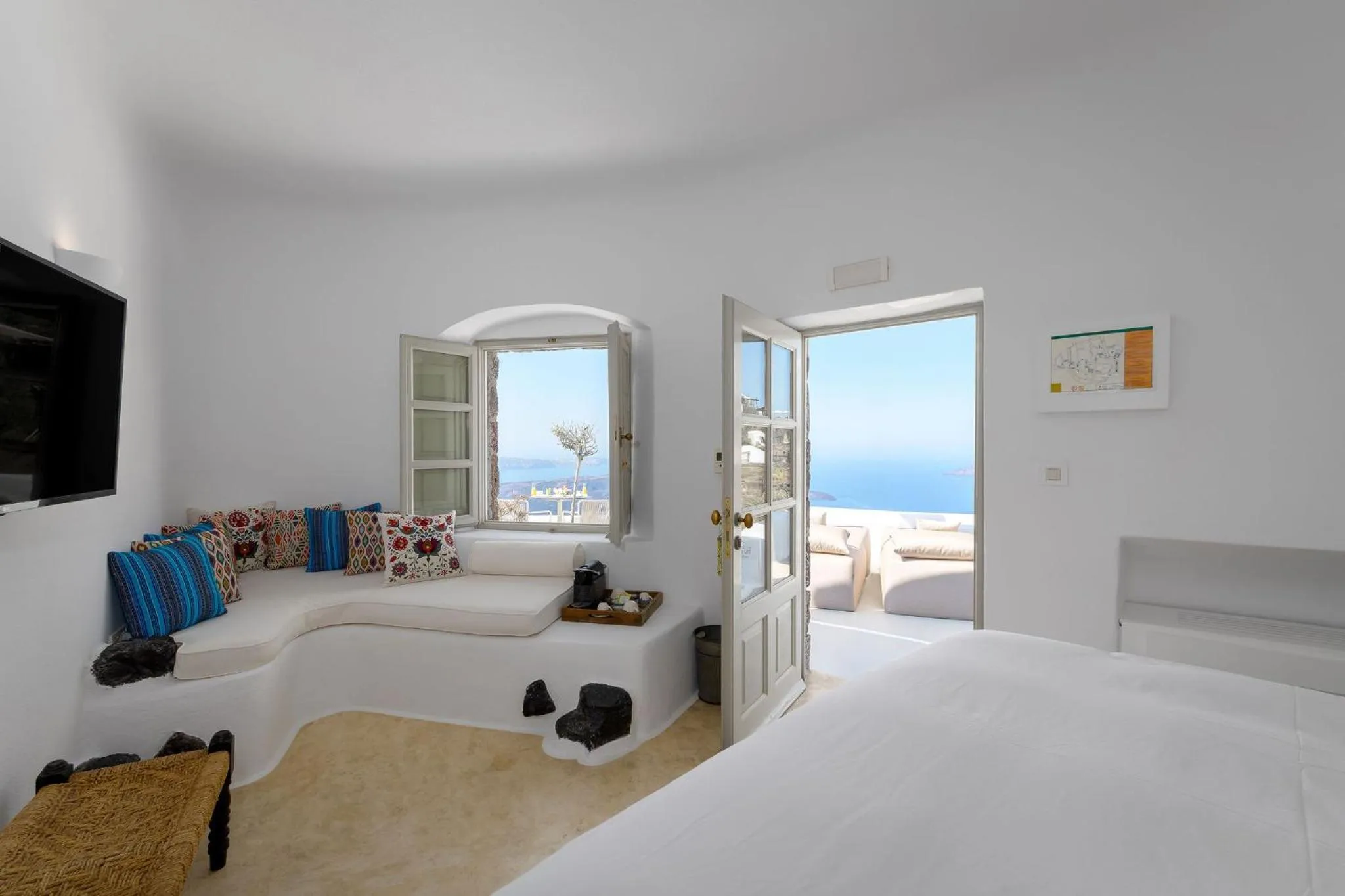 Seating area, Bed in Iconic Santorini, a Boutique Cave Hotel by Sandglass