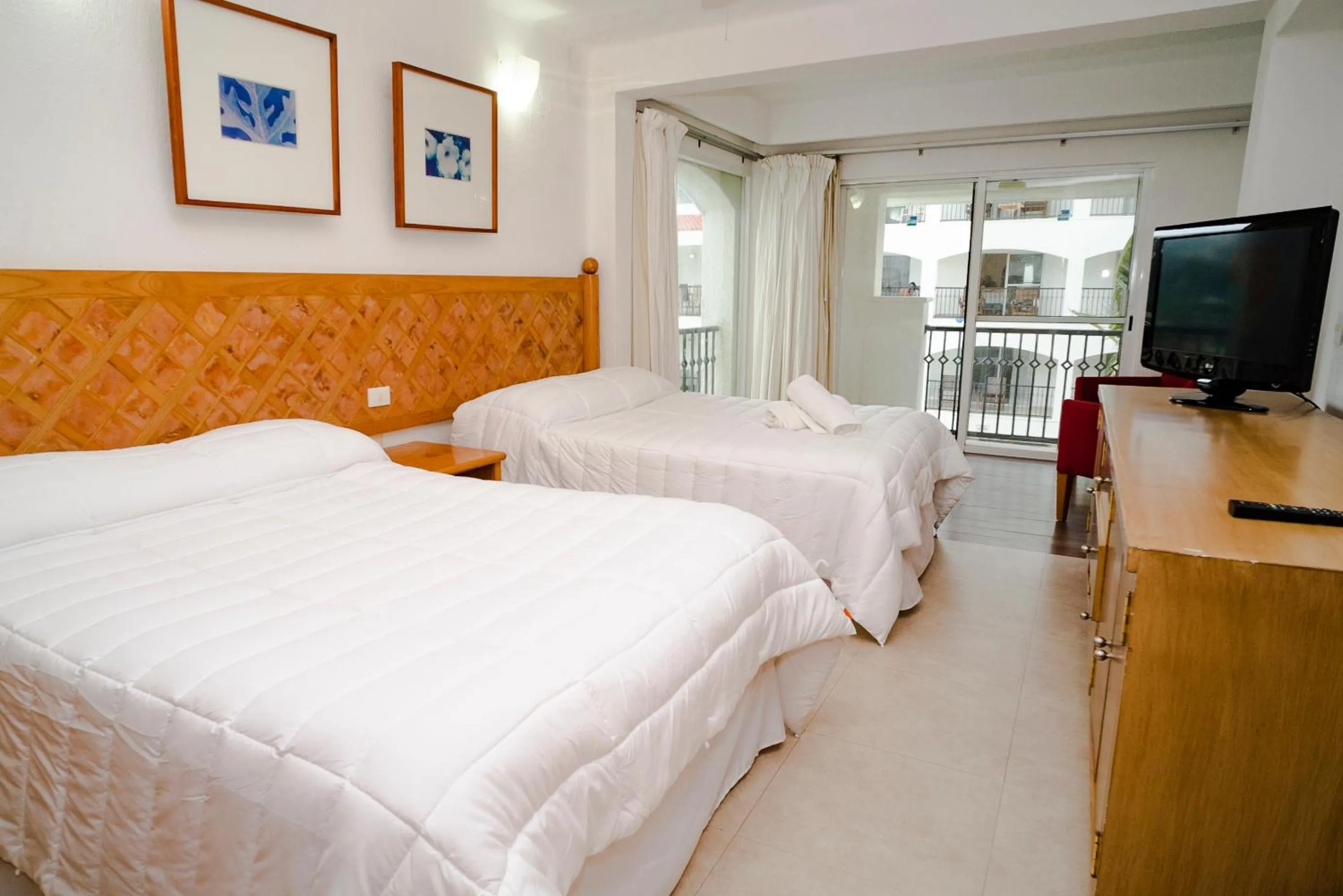 Photo of the whole room, Bed in Oceanfront condo at voted best Cancun sandy beach