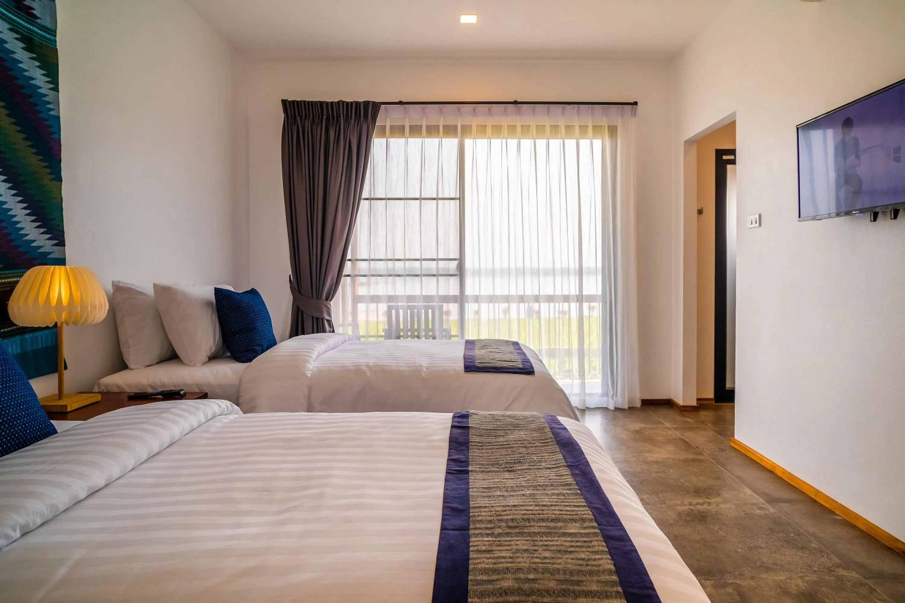 Bed in The Riviera Champasak