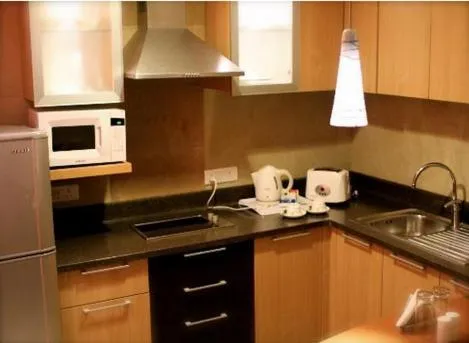 Kitchen or kitchenette in Savoy Suites Manesar