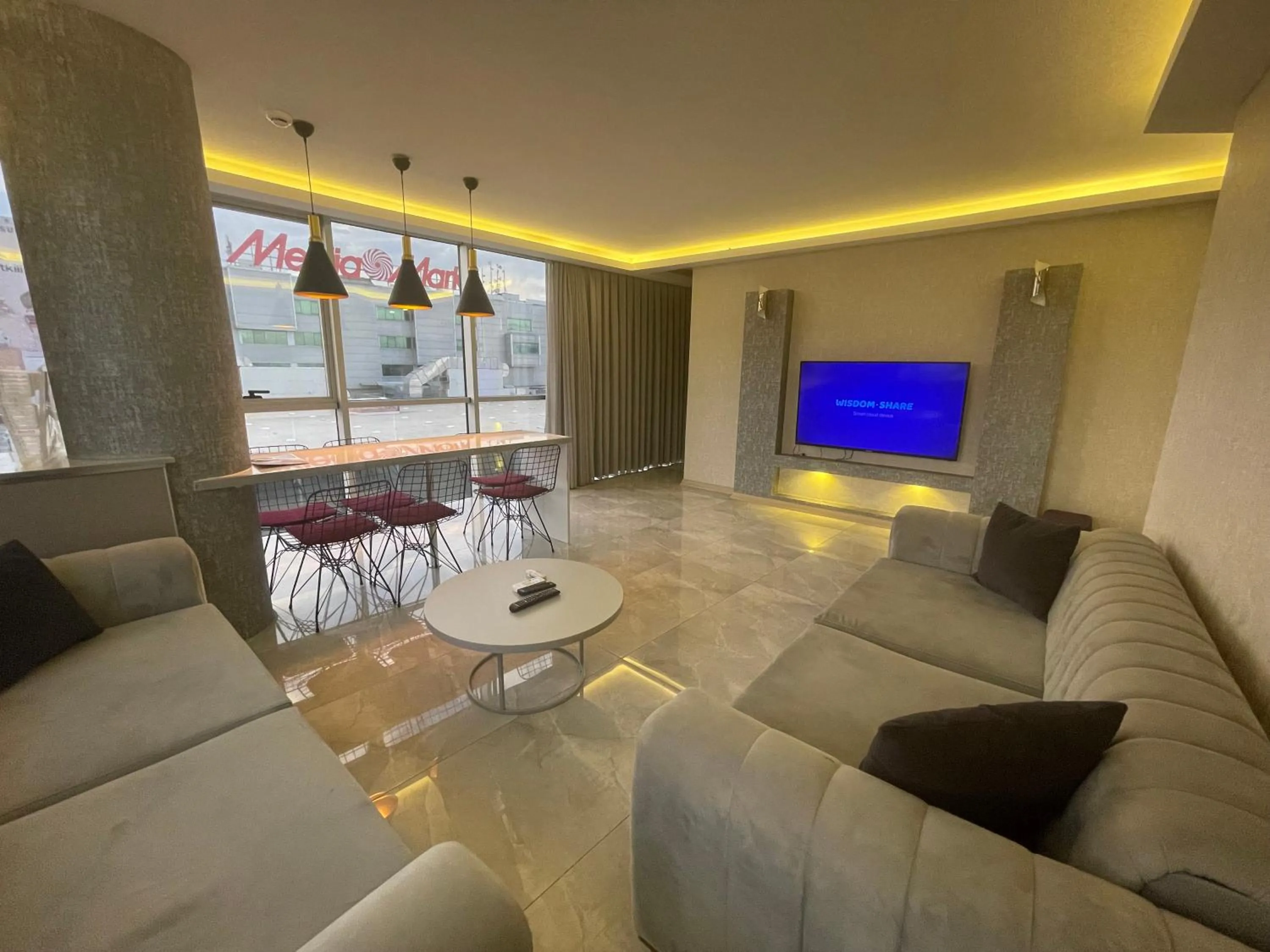 Communal lounge/ TV room in Le Luxe Suites Hotel