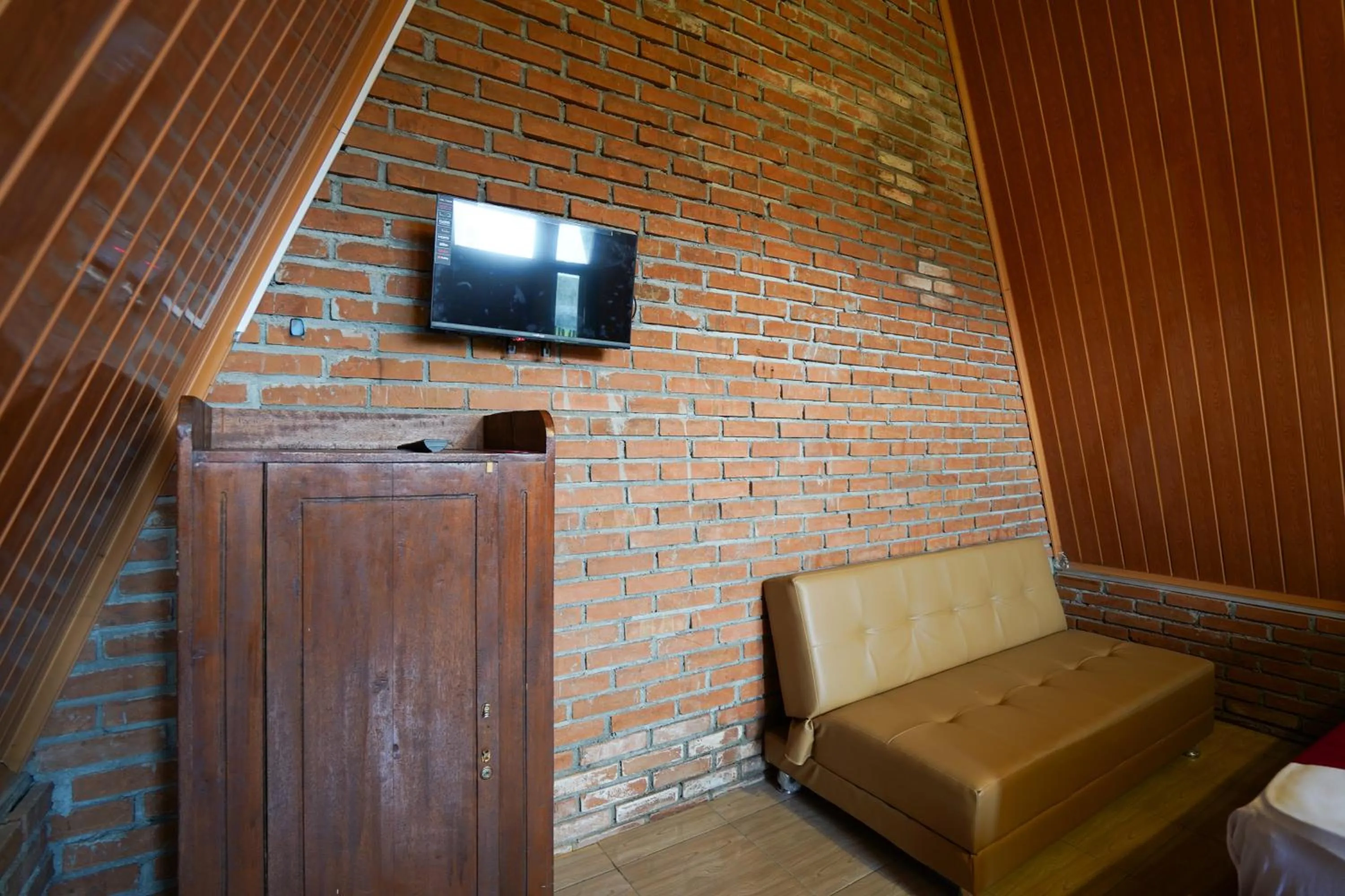 Seating area in RedDoorz at Omah Kayu Homestay Yogyakarta