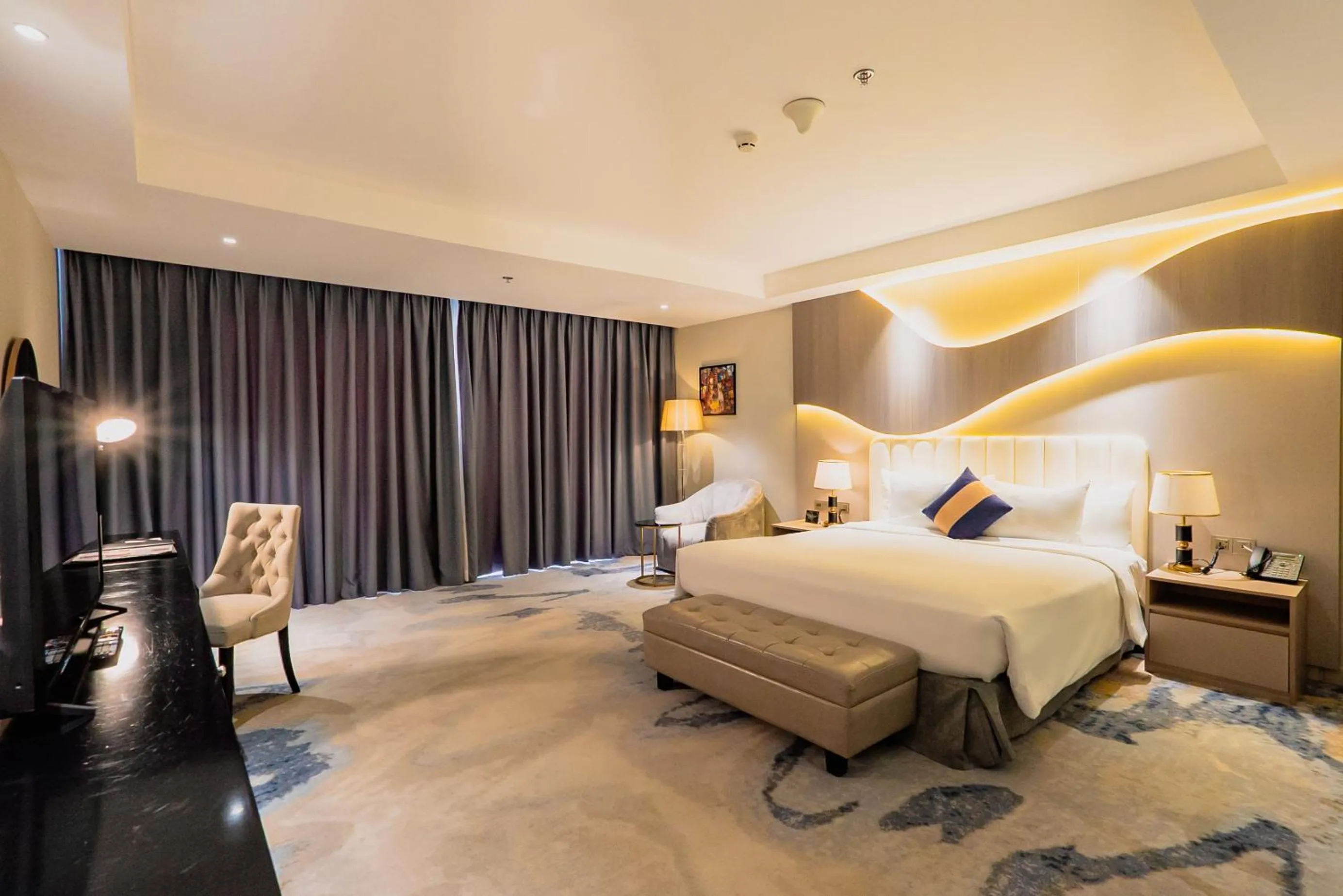 Bed in La Vela Saigon Hotel