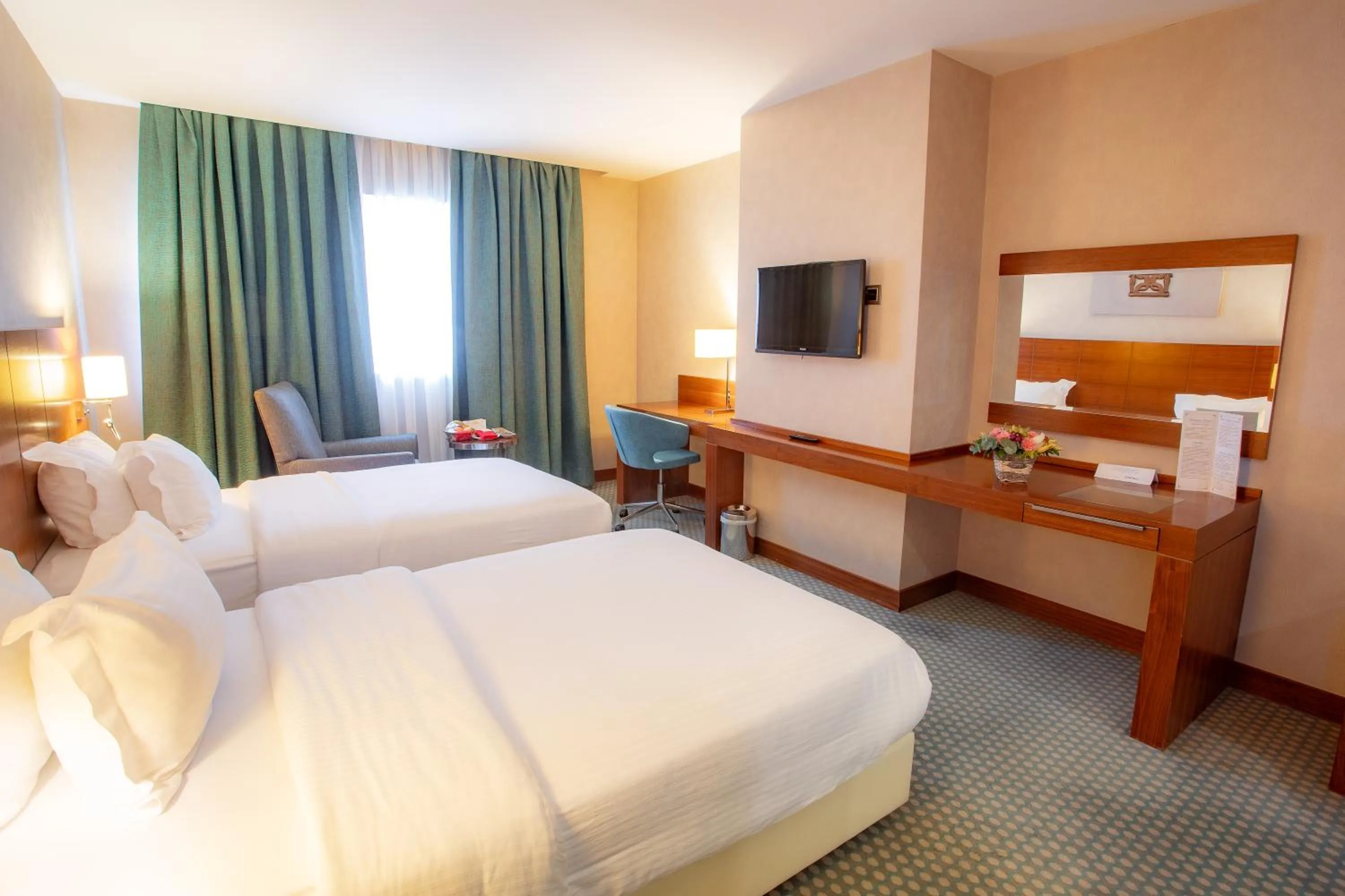 Communal lounge/ TV room, Bed in Nevali Hotel & Convention Center