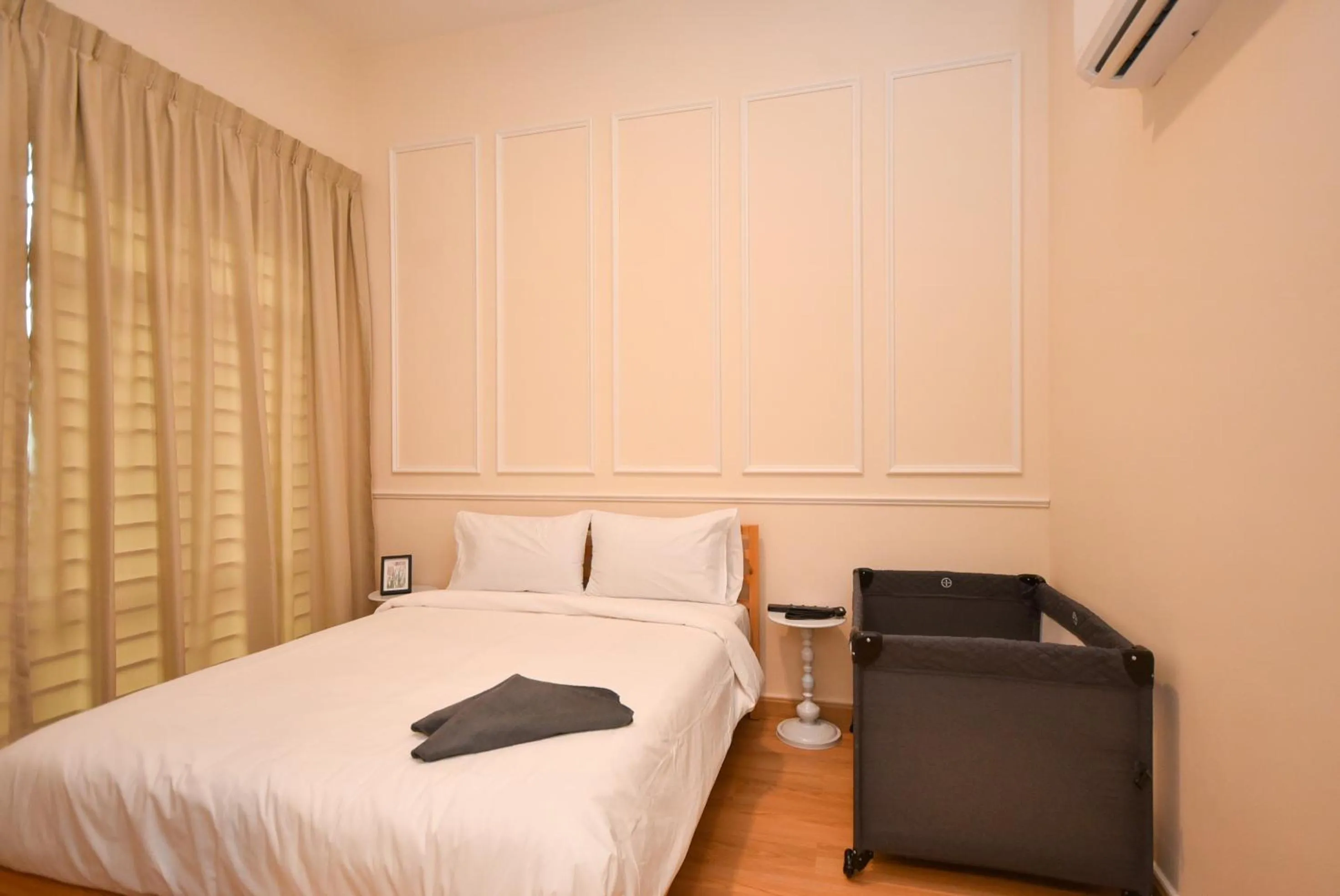 Bed in Manhattan Theme Suite by Nest Home at Austin Heights