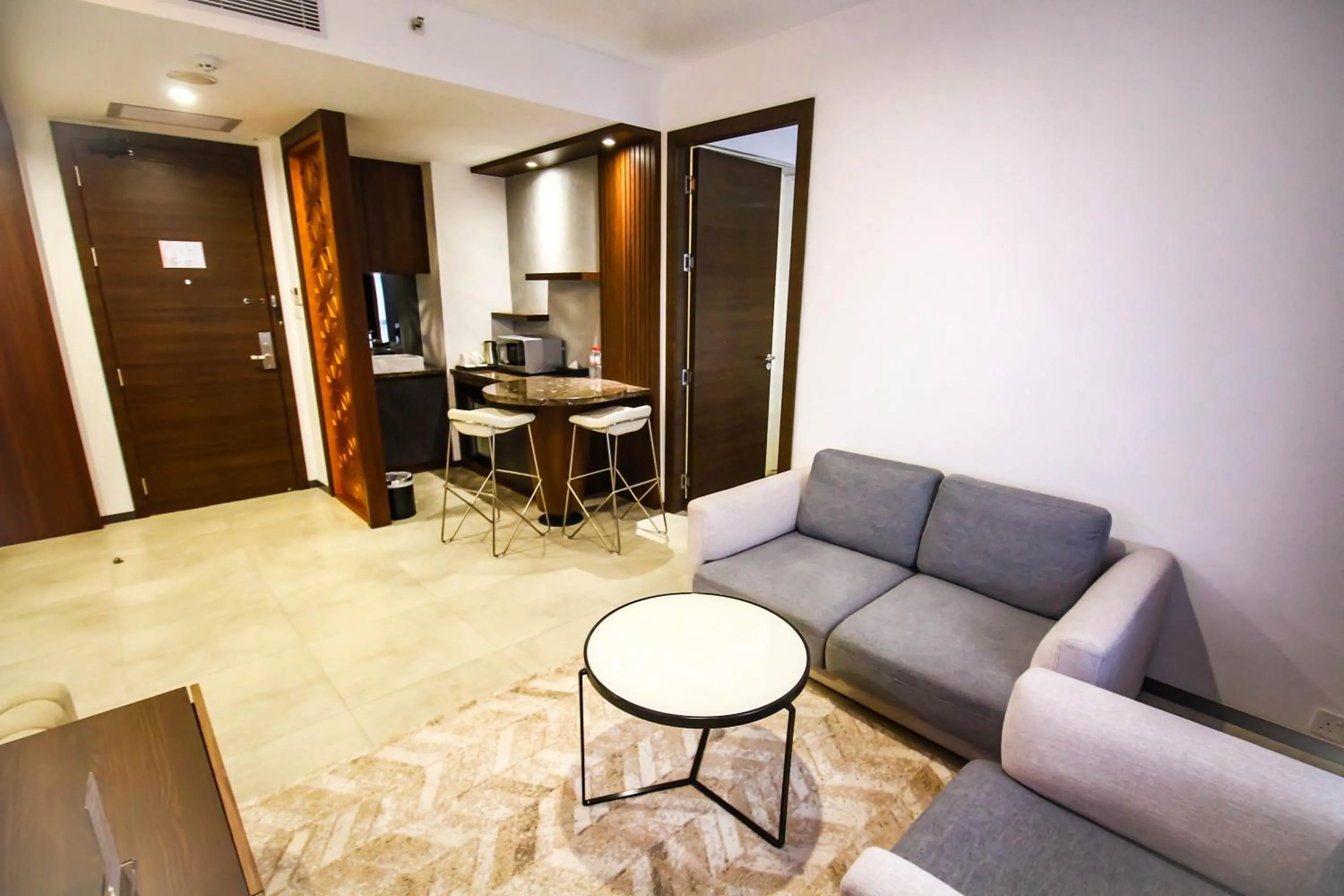 Living room in Asialink Hotel Batam by Prasanthi