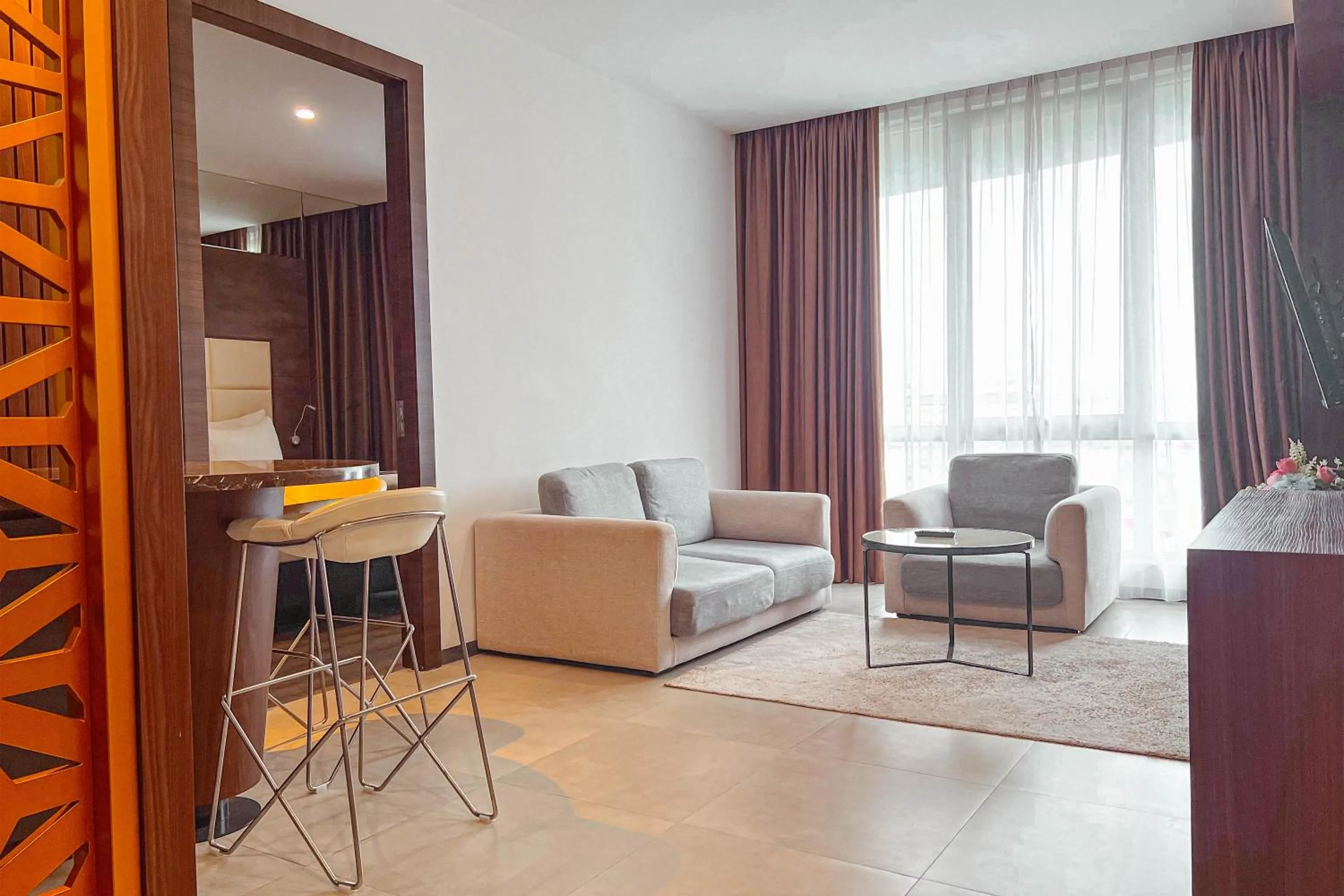 Living room in Asialink Hotel Batam by Prasanthi