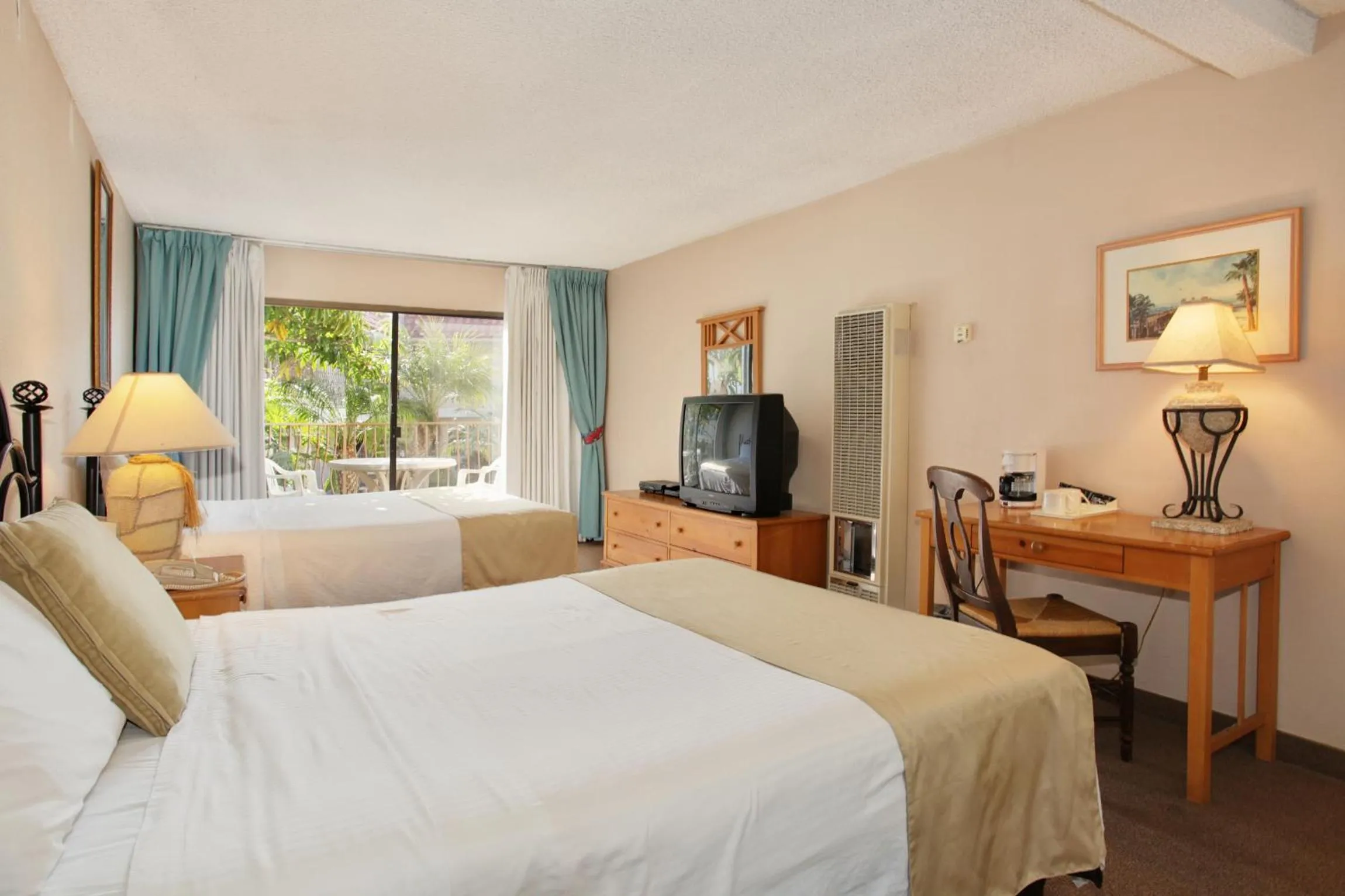 Bed in Oceanside Marina Suites - A Waterfront Hotel