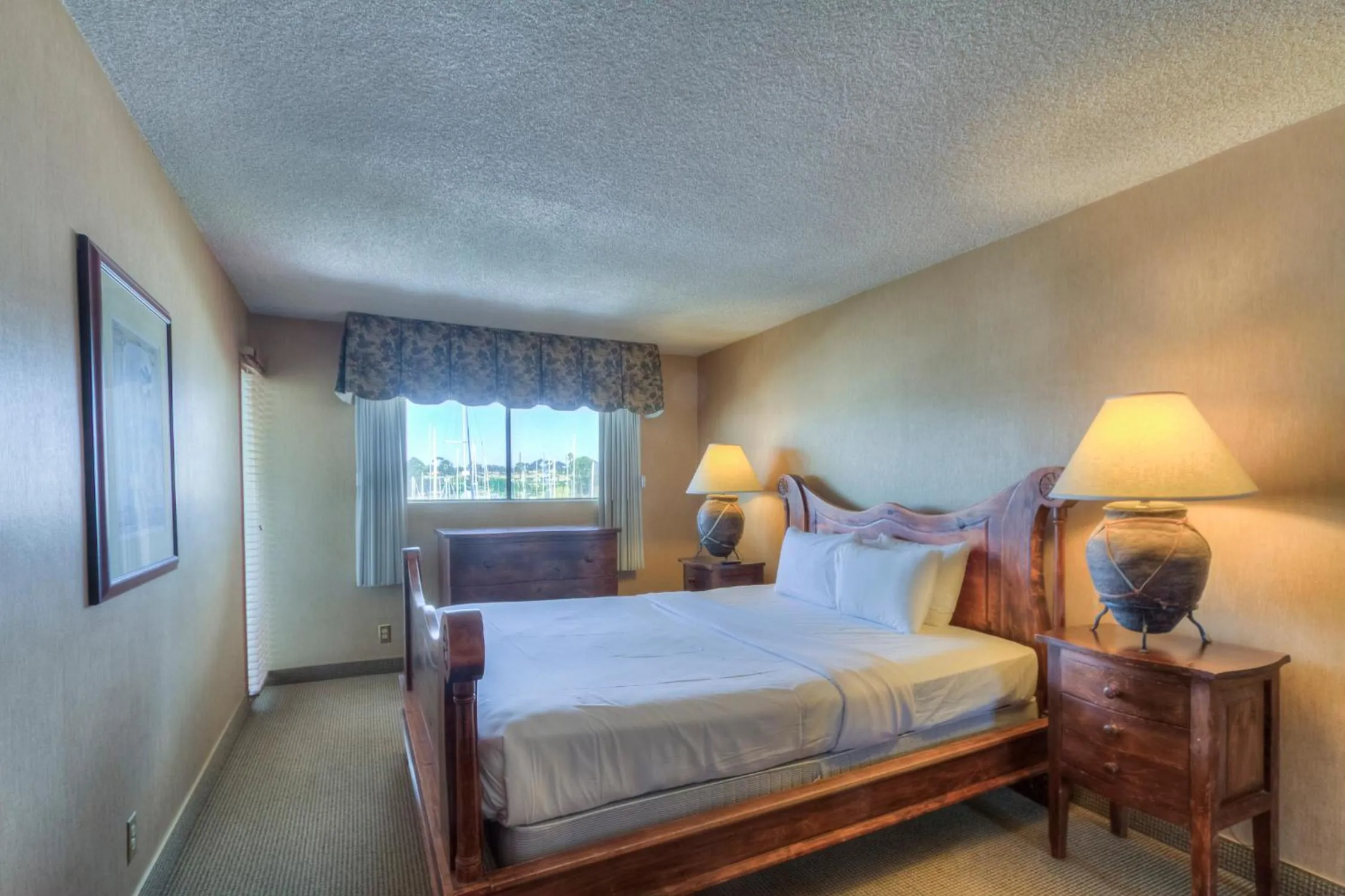 Bed in Oceanside Marina Suites - A Waterfront Hotel