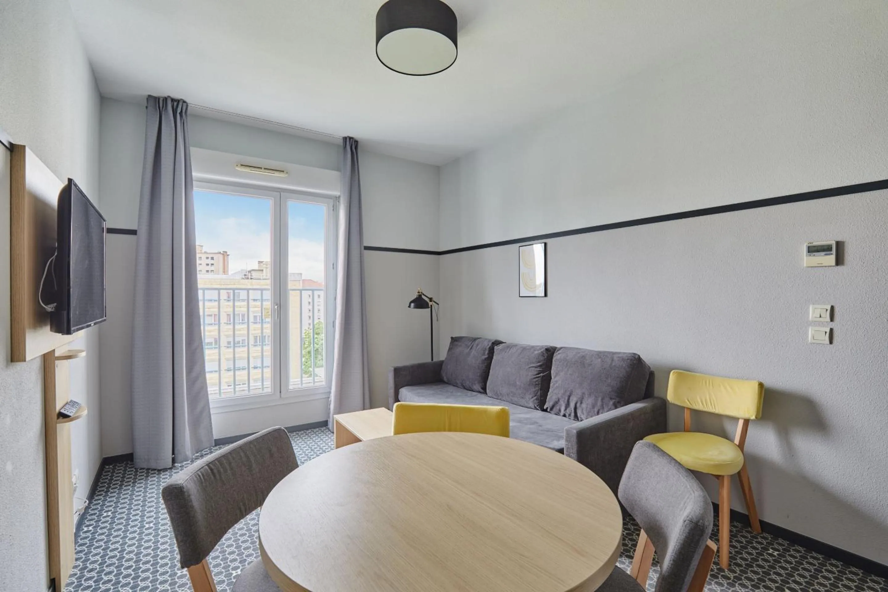 Living room in Appart'hôtel Odalys City - Bioparc Lyon Est