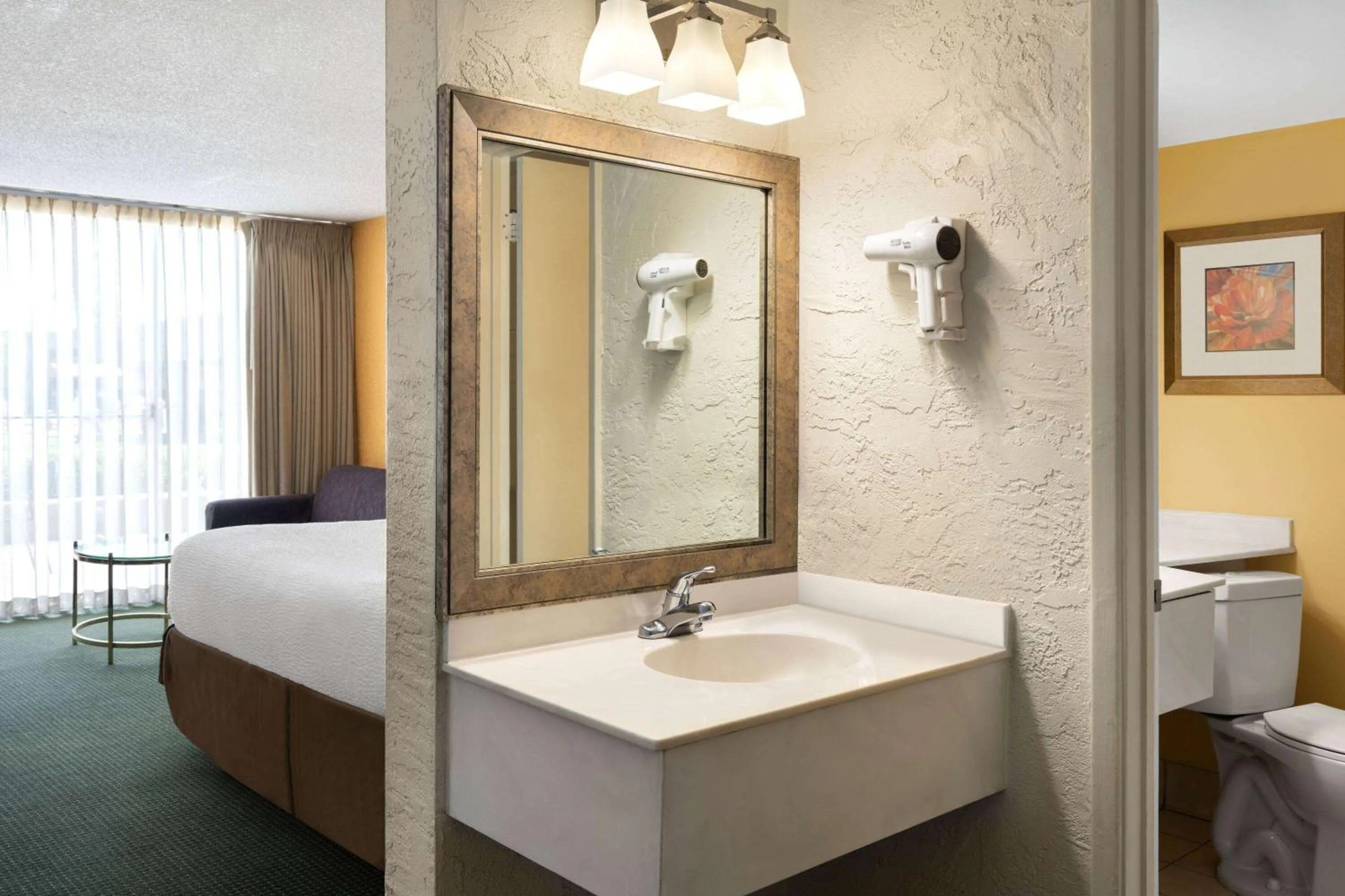 Bathroom, Bed in Ramada by Wyndham Tucson
