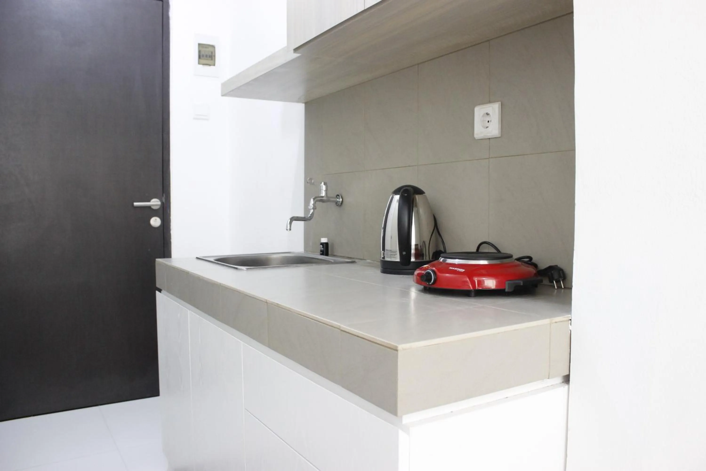 Kitchen or kitchenette in Monochrome Style Studio Room @Grand Asia Afrika Apartment By Travelio