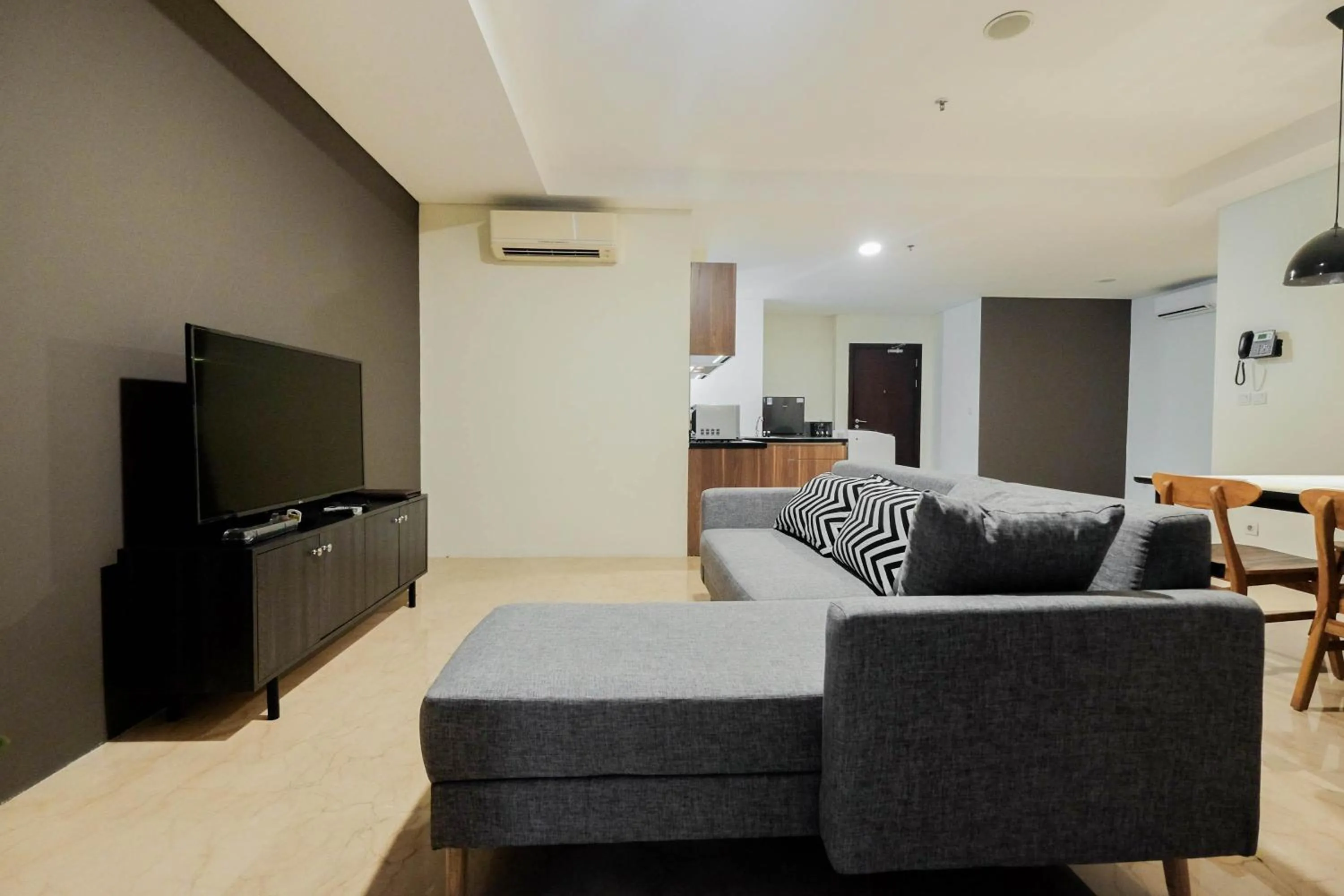 Living room in Comfy 3BR at L'Avenue Apartment Pancoran By Travelio