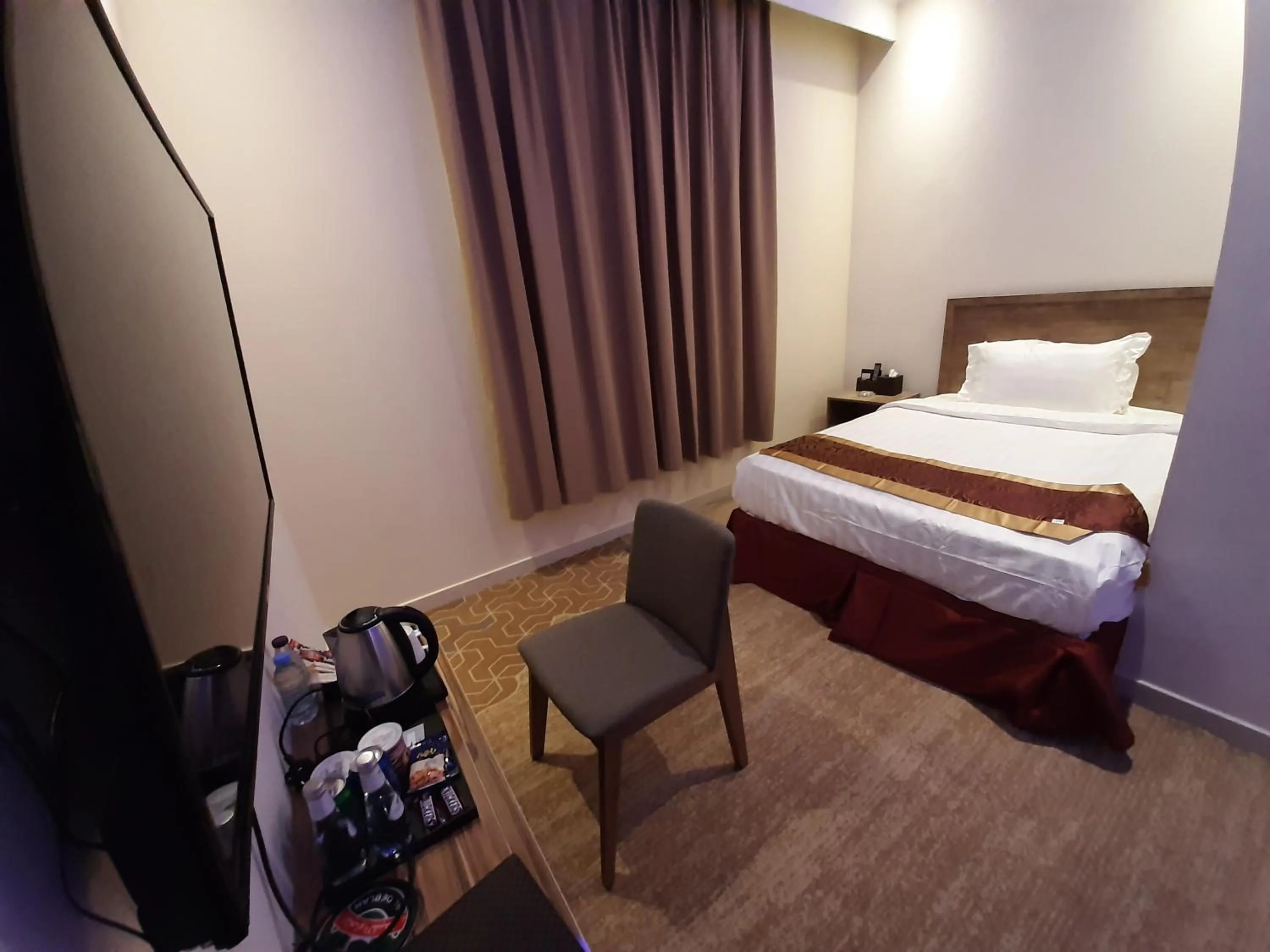 Bed in Qasr Alshamal Hotel