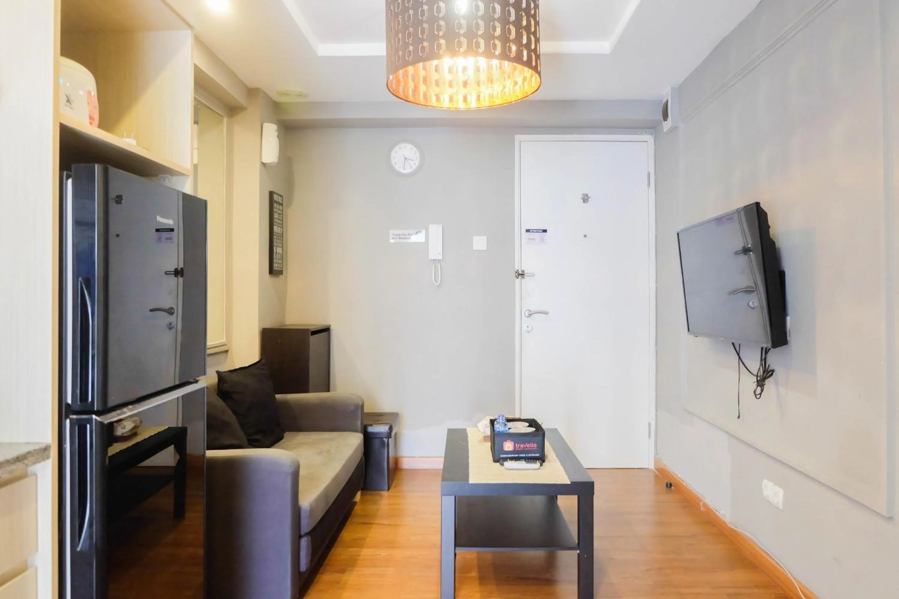 Living room in Exclusive and Spacious 1BR Apartment at Bassura City By Travelio