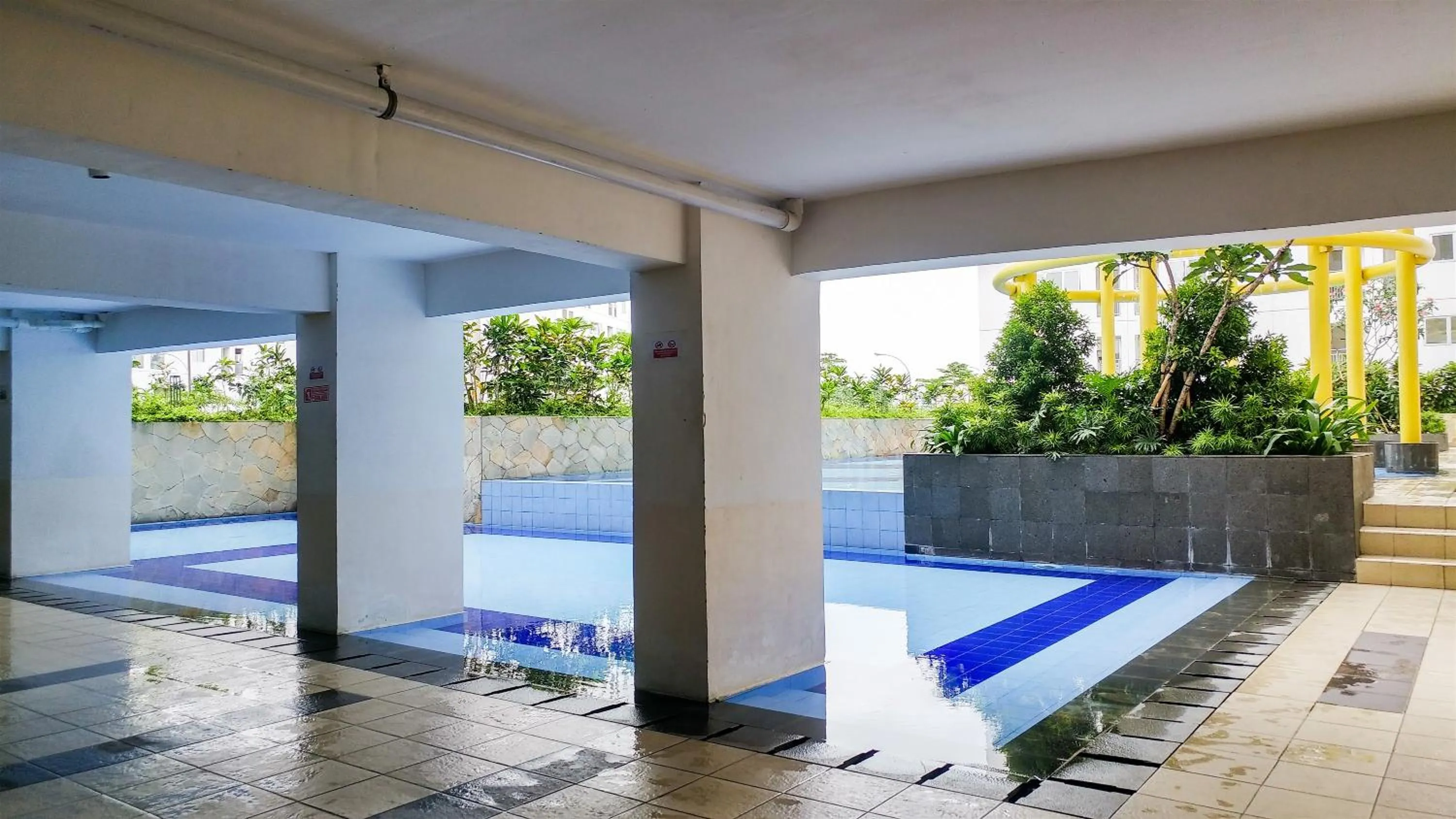 Swimming pool in Tidy Studio Apartment at Bassura City near Shopping Mall By Travelio