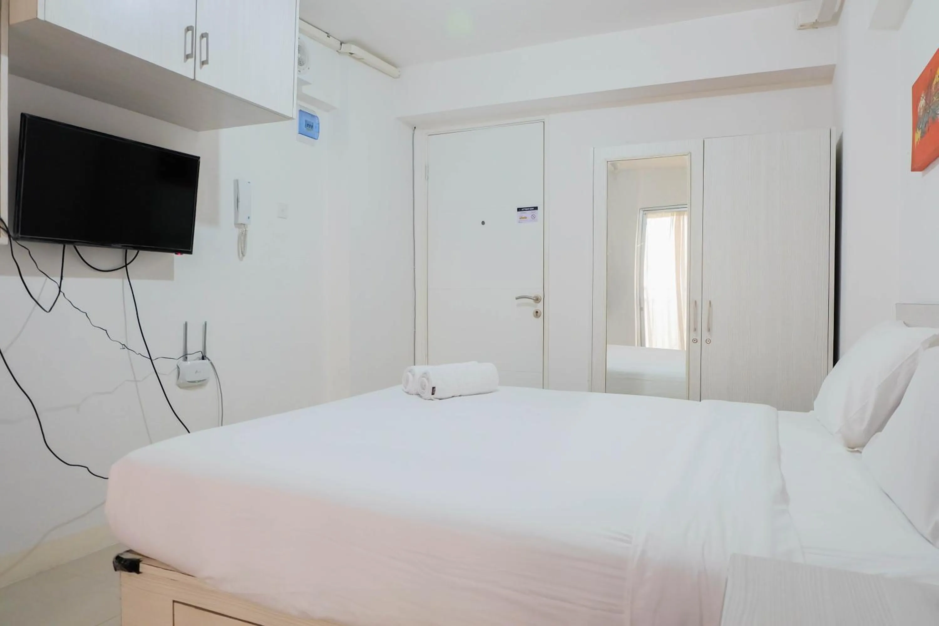 Bed in Tidy Studio Apartment at Bassura City near Shopping Mall By Travelio