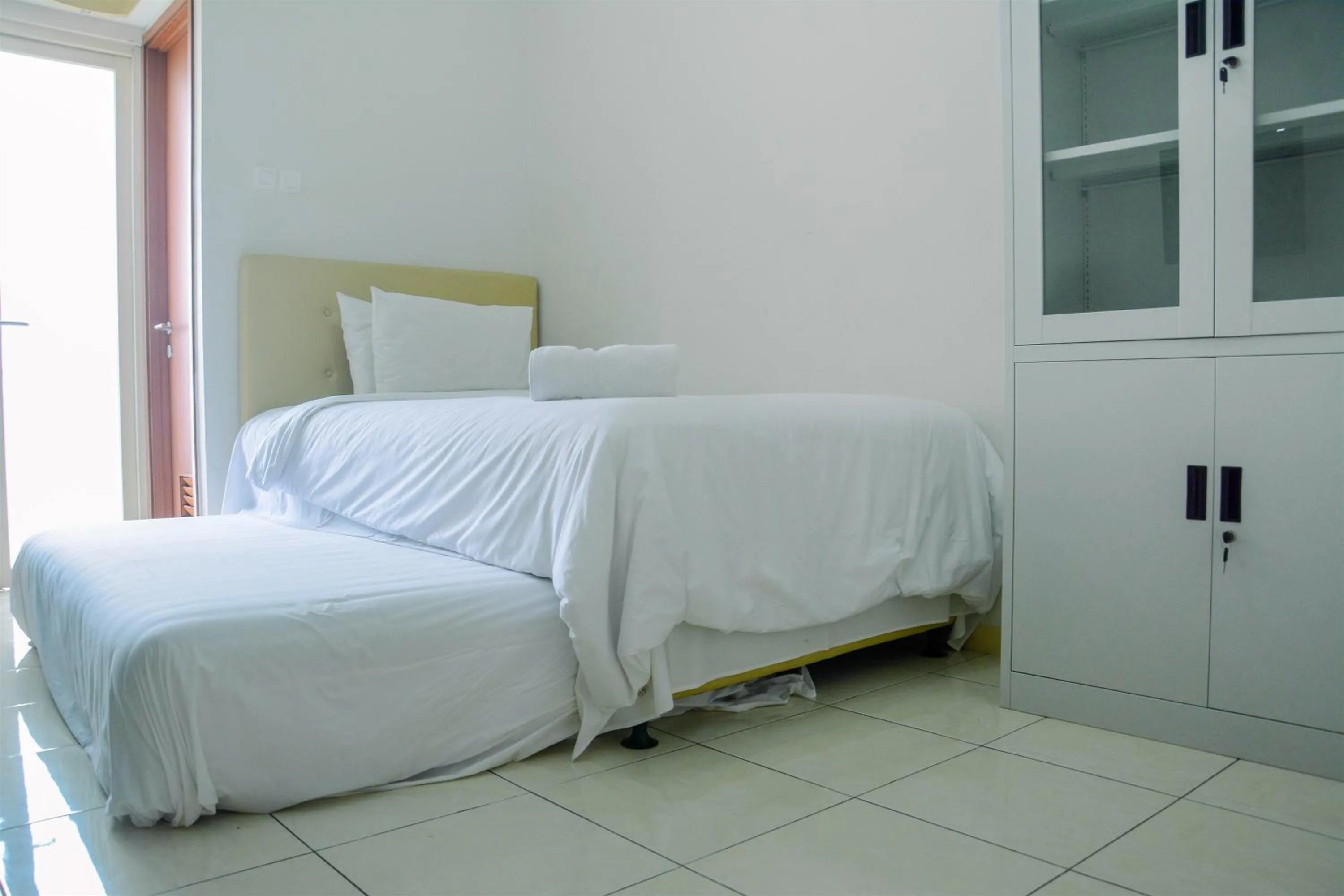 Bed in Cozy Studio Apartment at Margonda Residence 4 By Travelio