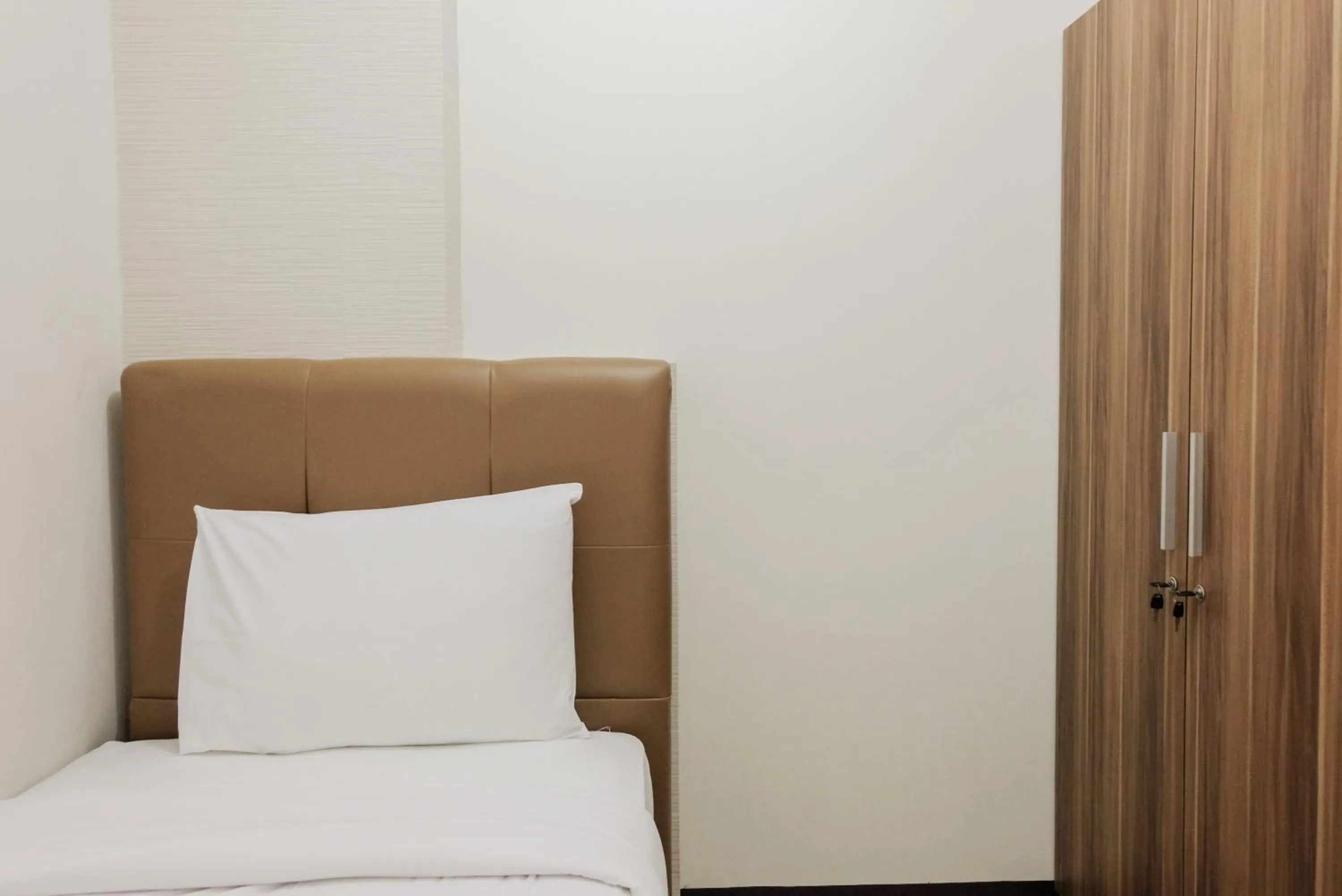 Bed in Luxurious and Convenient 2BR 19 Avenue Apartment By Travelio