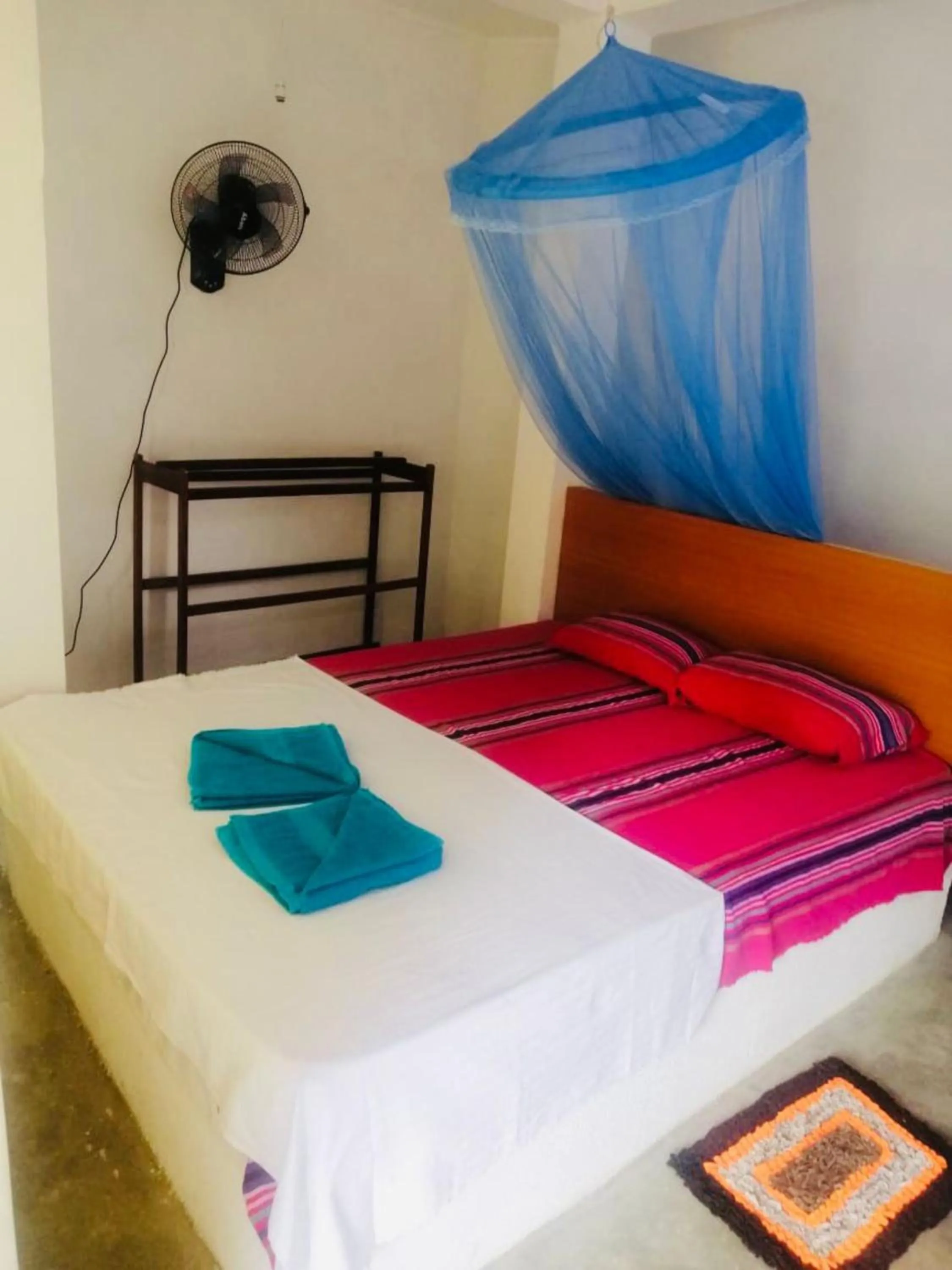 Bed in Hiriketiya Orchid Villa