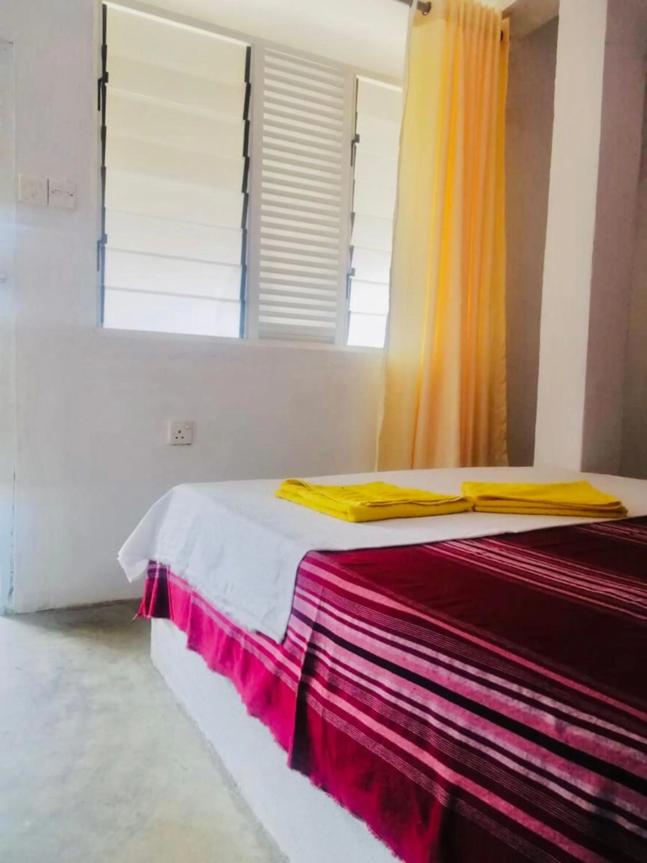 Bed in Hiriketiya Orchid Villa