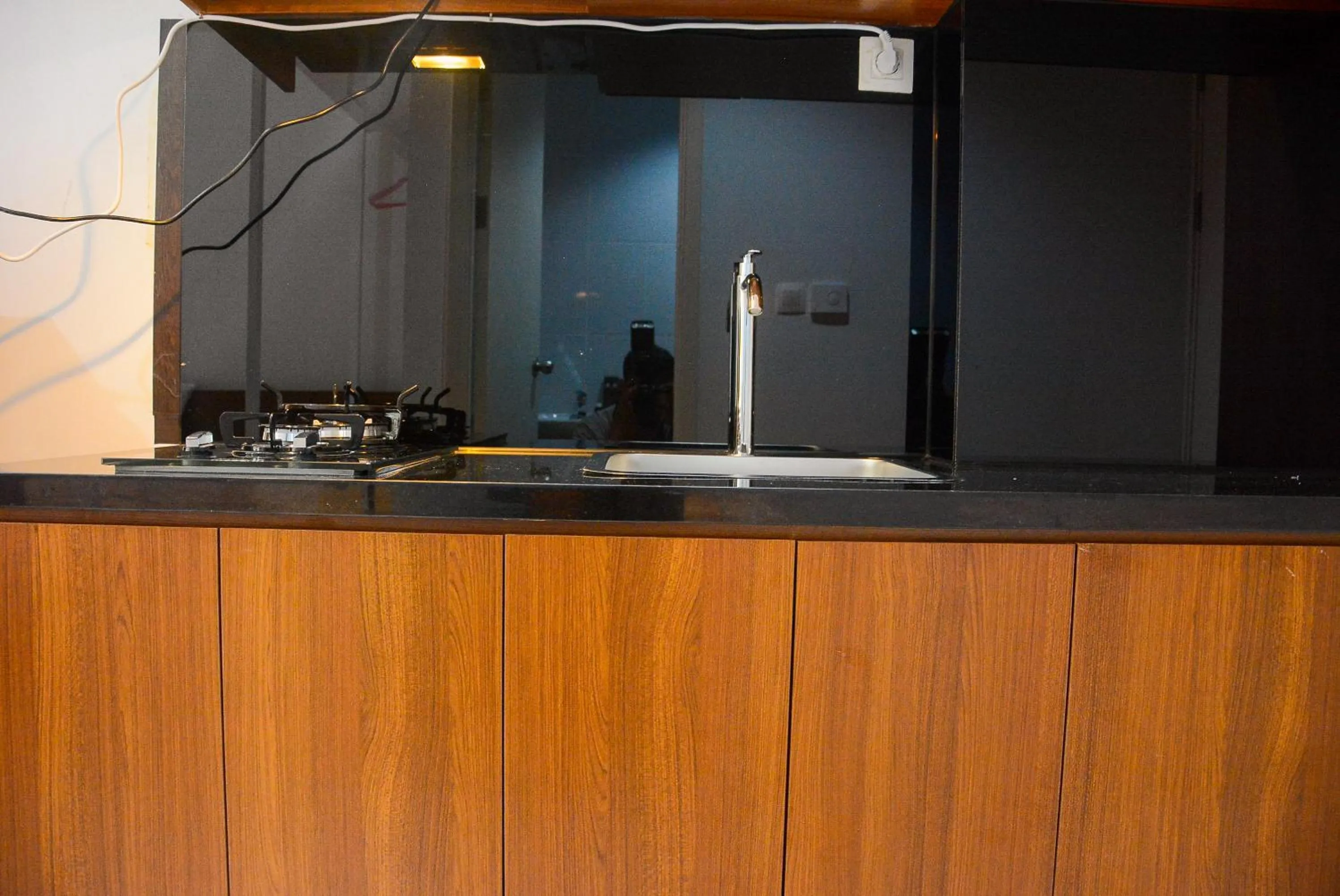 Kitchen or kitchenette in Comfy Studio Room at Patraland Urbano Apartment By Travelio