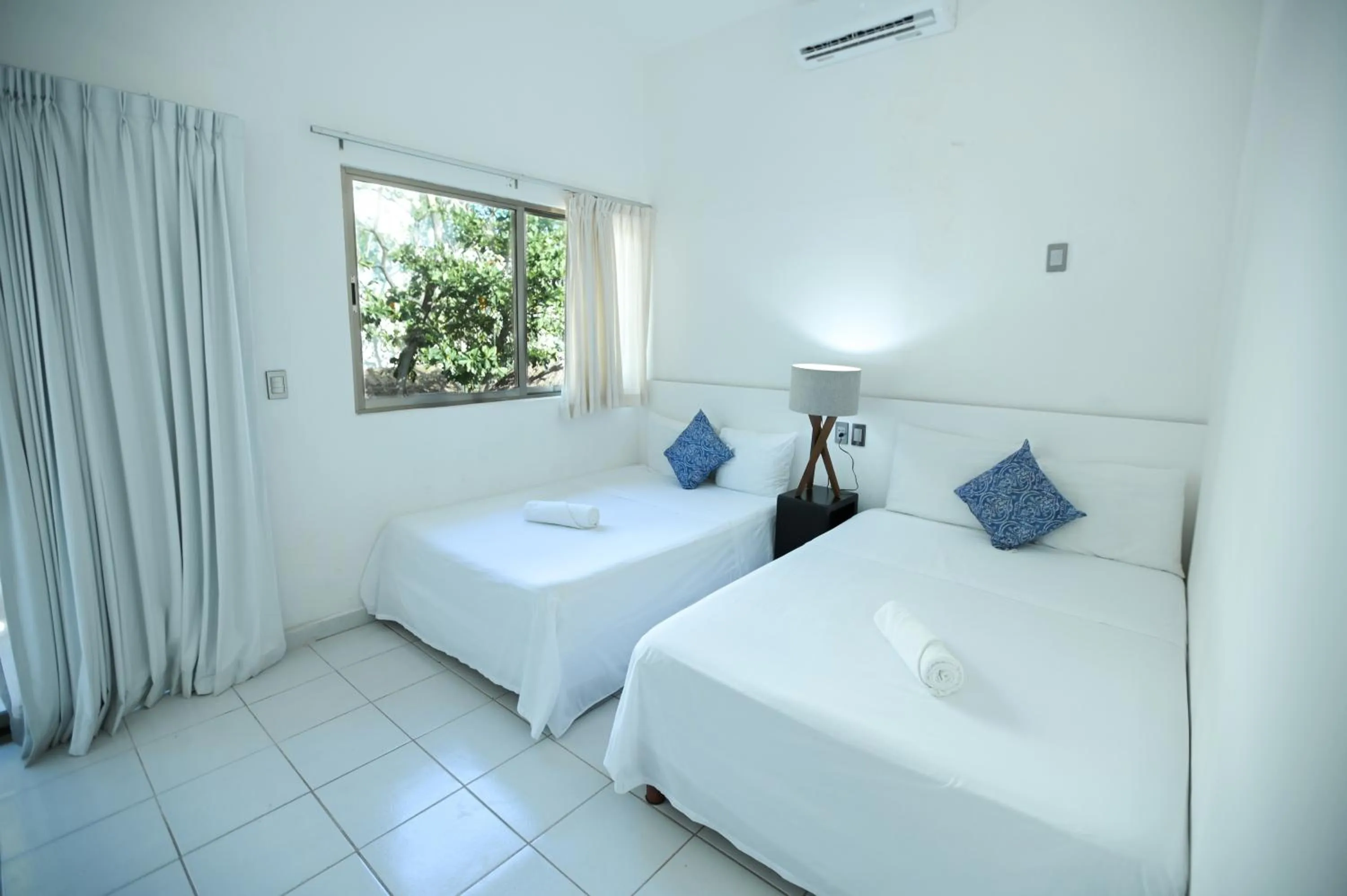 Bed in Kinta Kan Cabañas Hotel Playa del Carmen