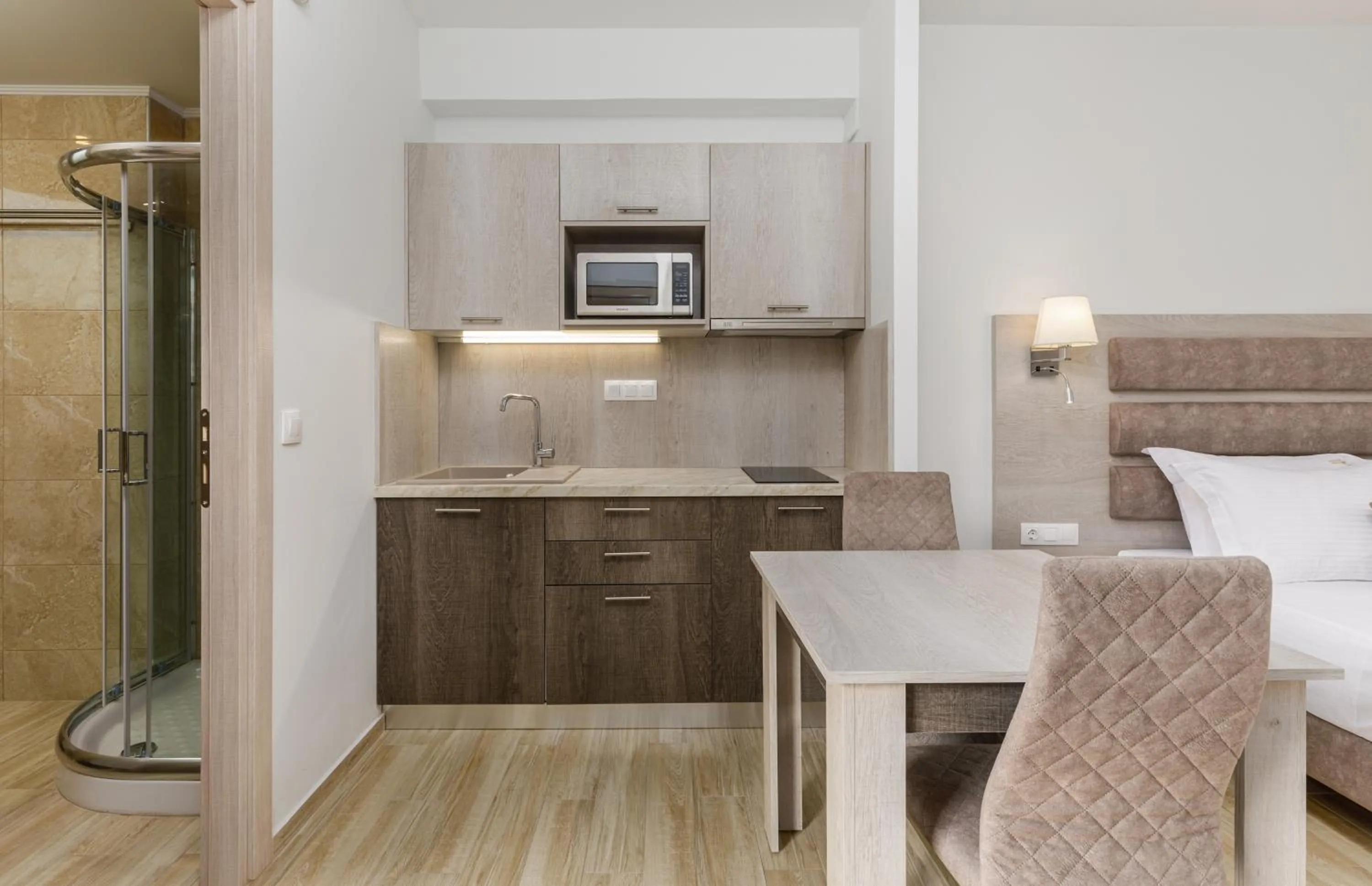 Kitchen or kitchenette, Bed in Aria Garden Suites