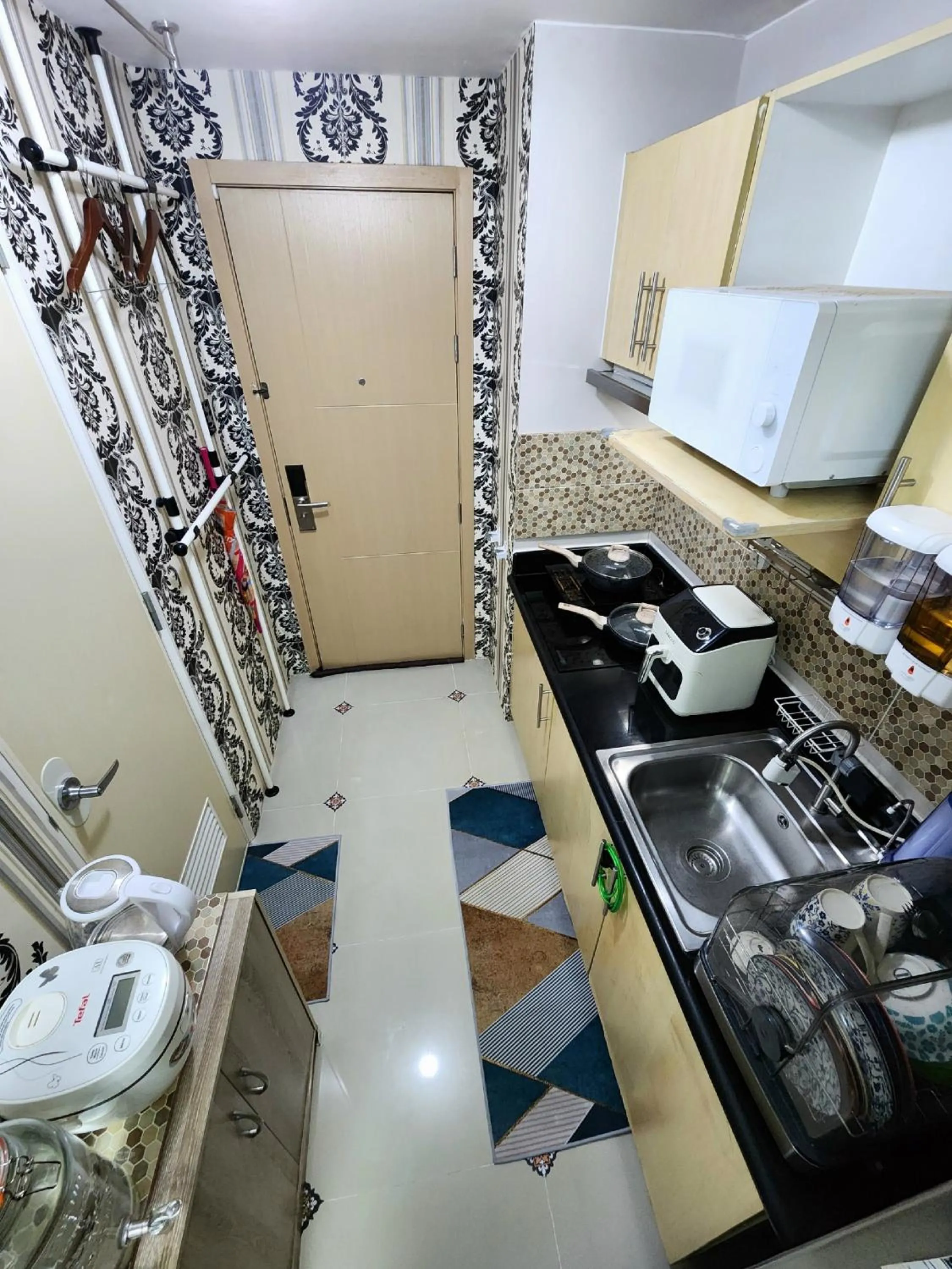Kitchen or kitchenette in High-Tech Studio at Grass Residences -2 persons only, Quezon City