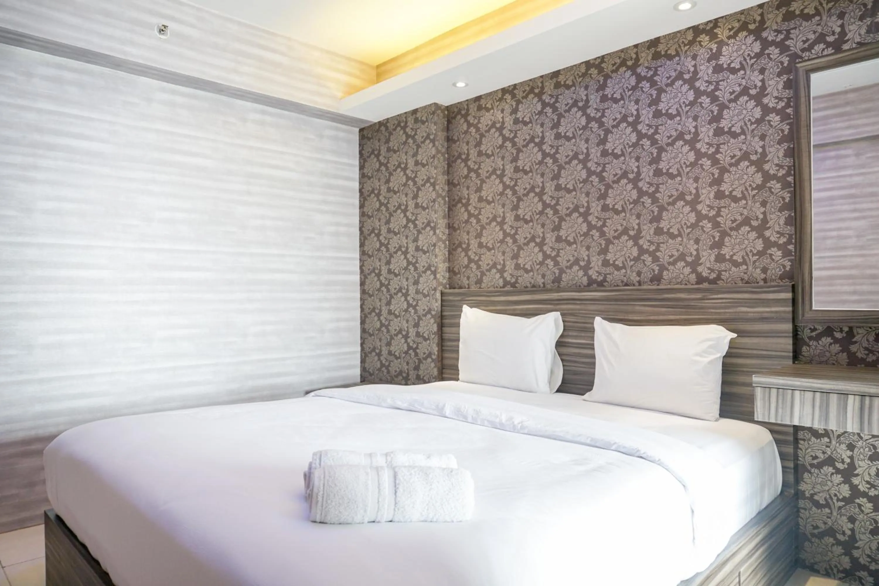 Bed in Comfortable 3BR Apartment at Green Palm Residences By Travelio