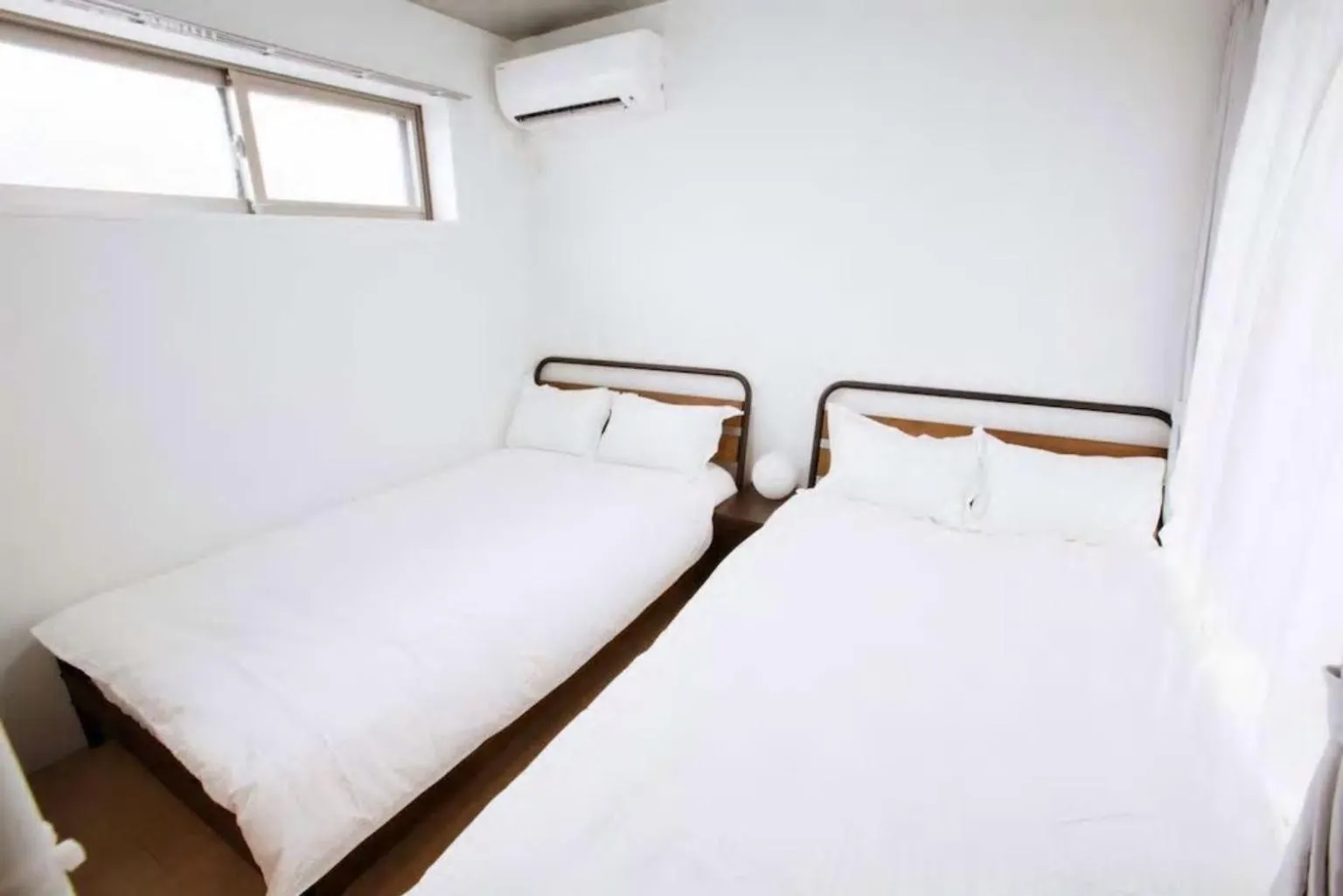 Bed in Laffitte Hirai Condominium Hotel