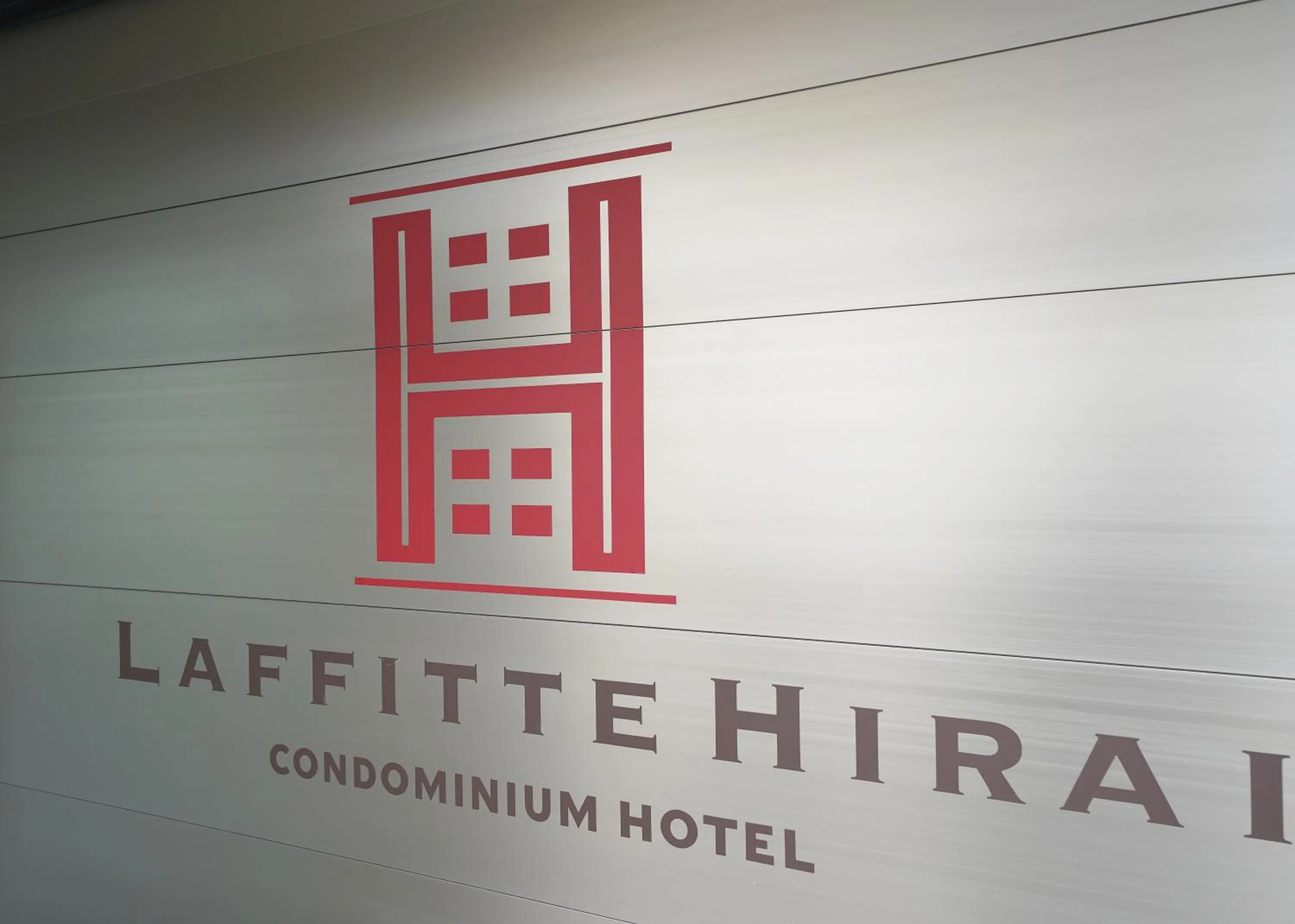 Property logo or sign in Laffitte Hirai Condominium Hotel