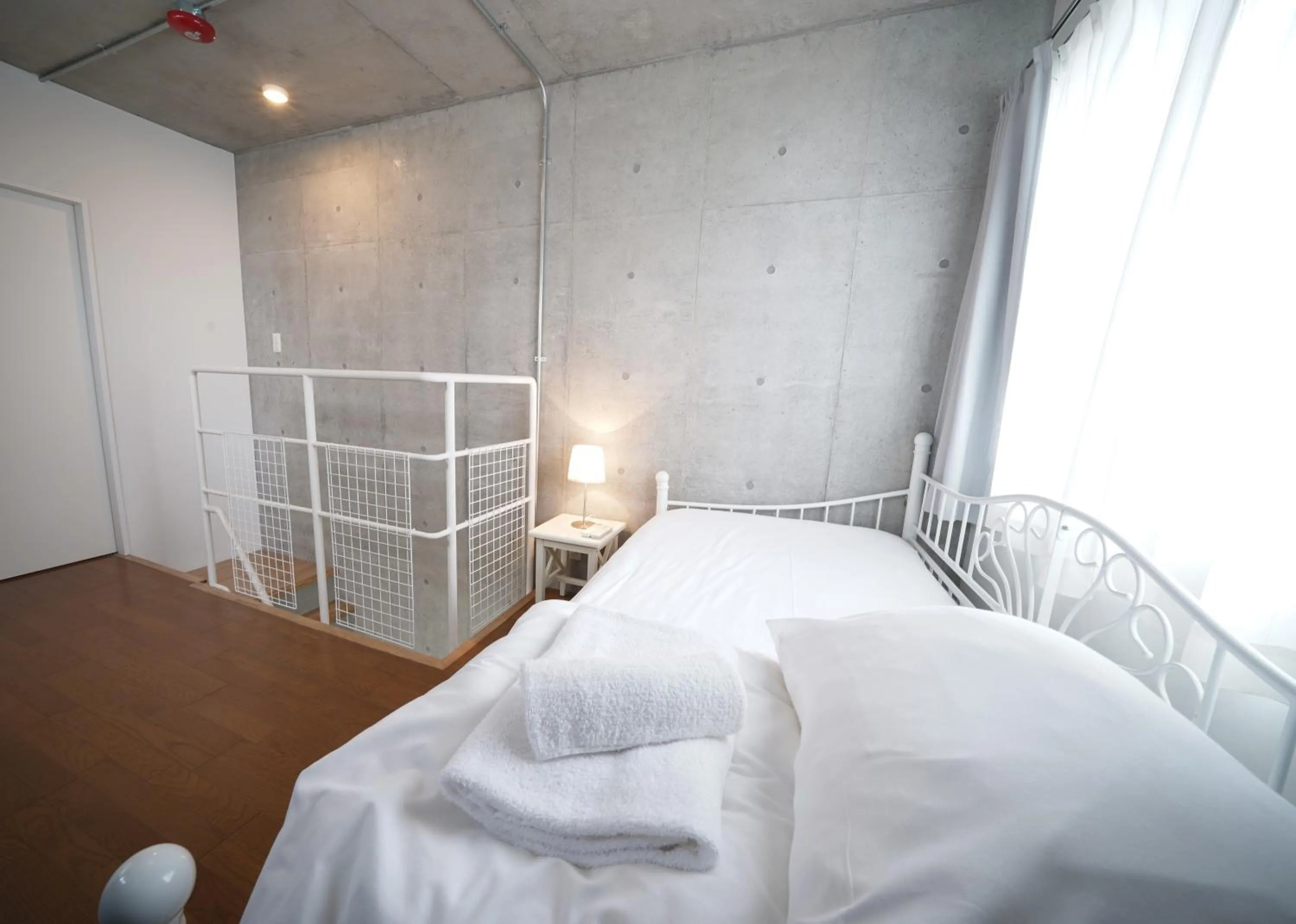 Bed in Laffitte Hirai Condominium Hotel