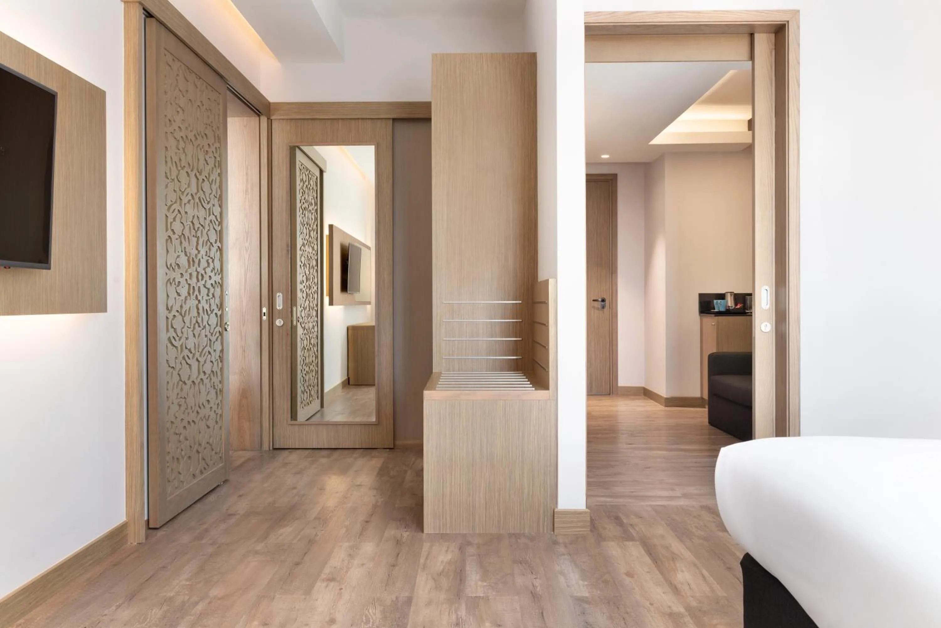 Living room, Bed in Ramada Encore by Wyndham Muscat Al-Ghubra