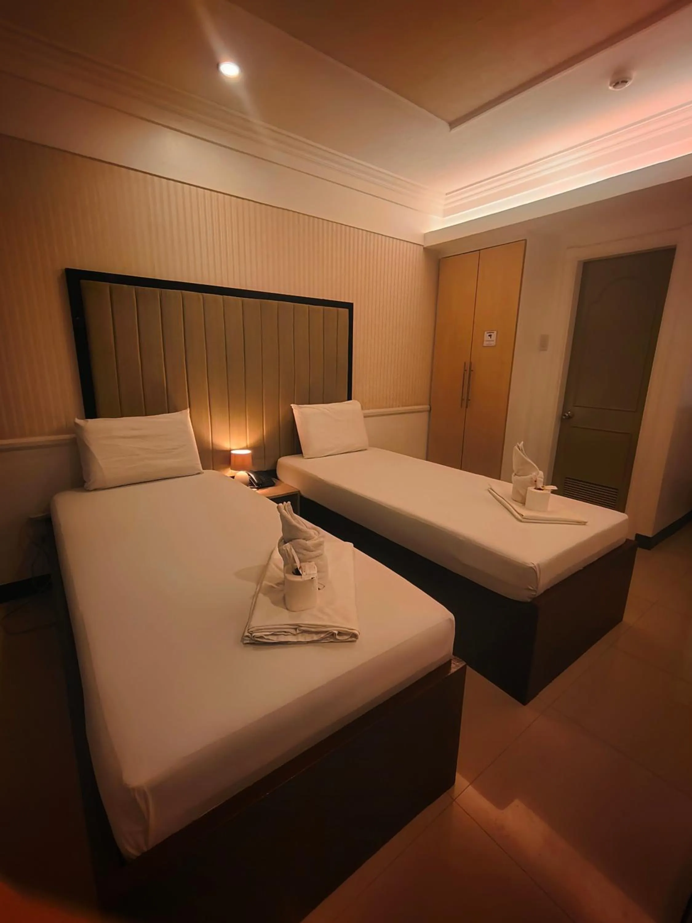 Toilet, Bed in S and M Hotel Inc.