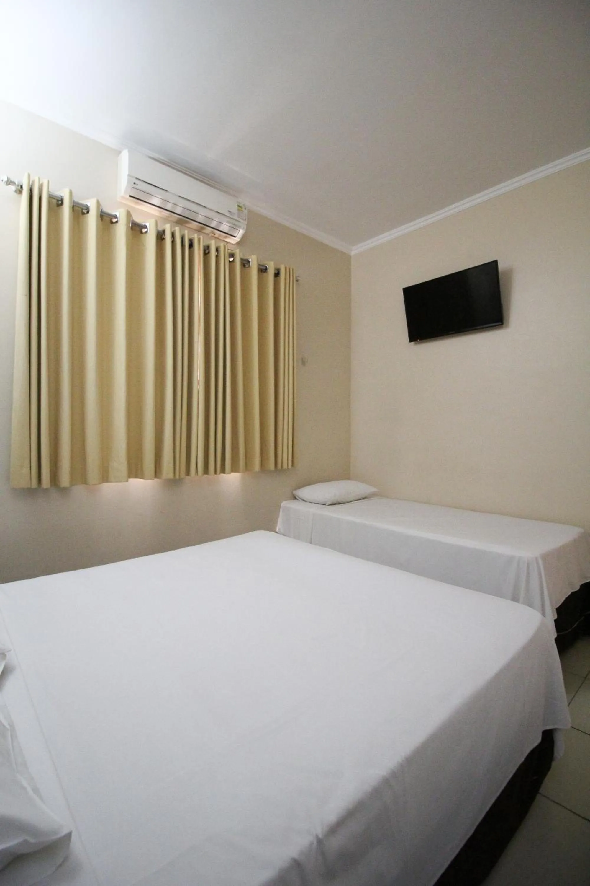 Bed in VOA Pousada Água Eterna