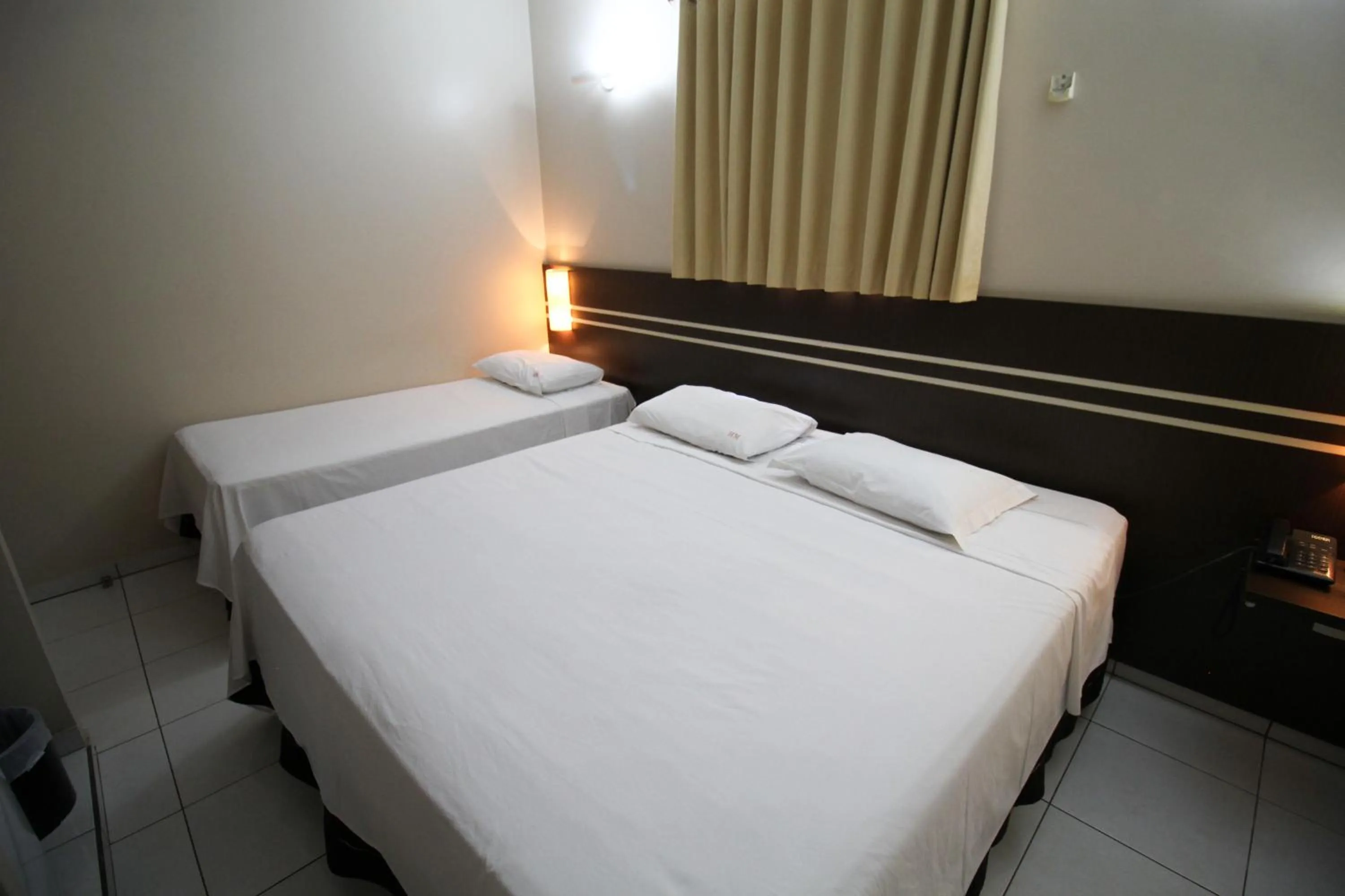 Bed in VOA Pousada Água Eterna