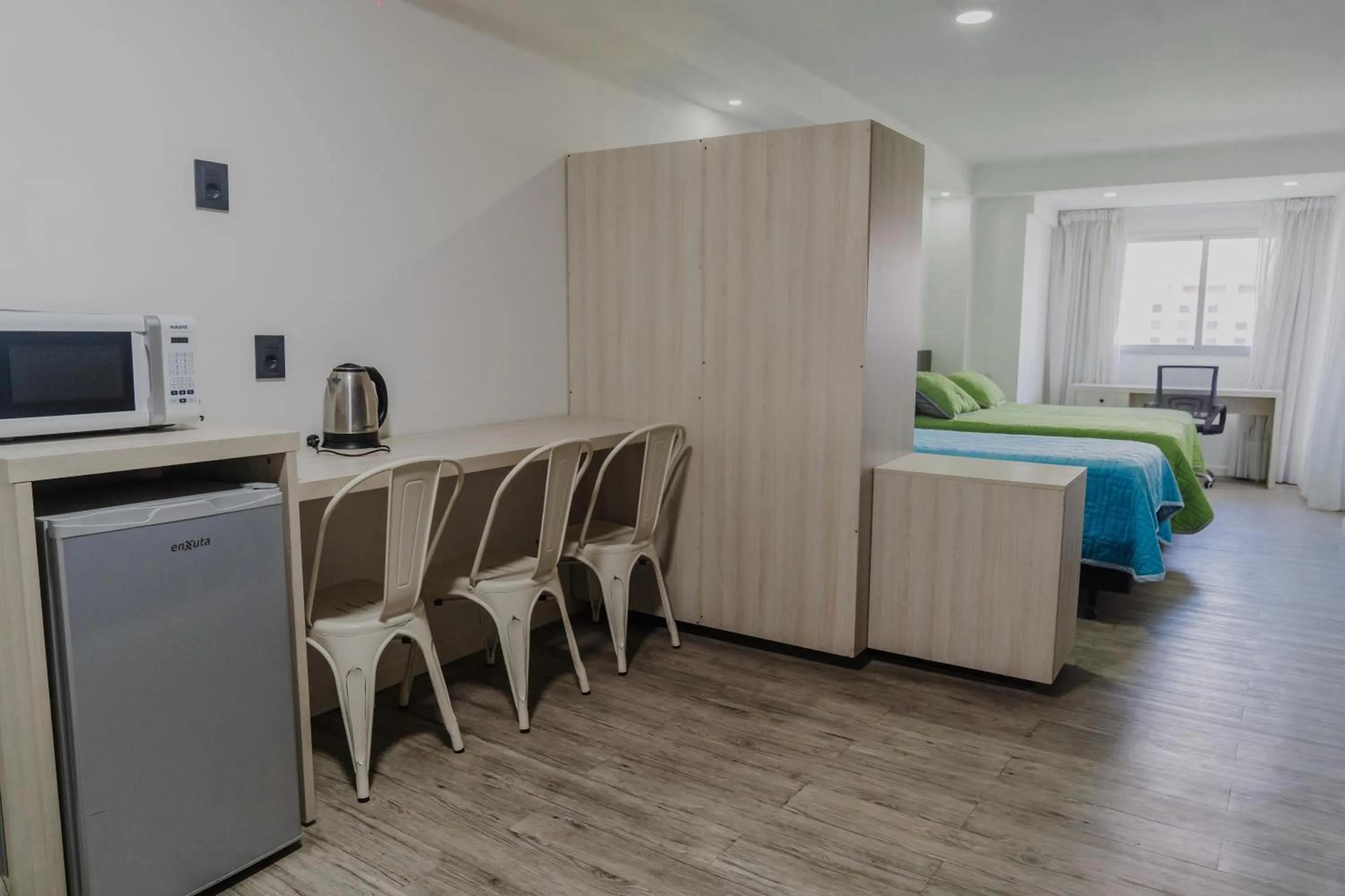 Kitchen or kitchenette, Bed in Quijano Hotel - Aparts & Suites